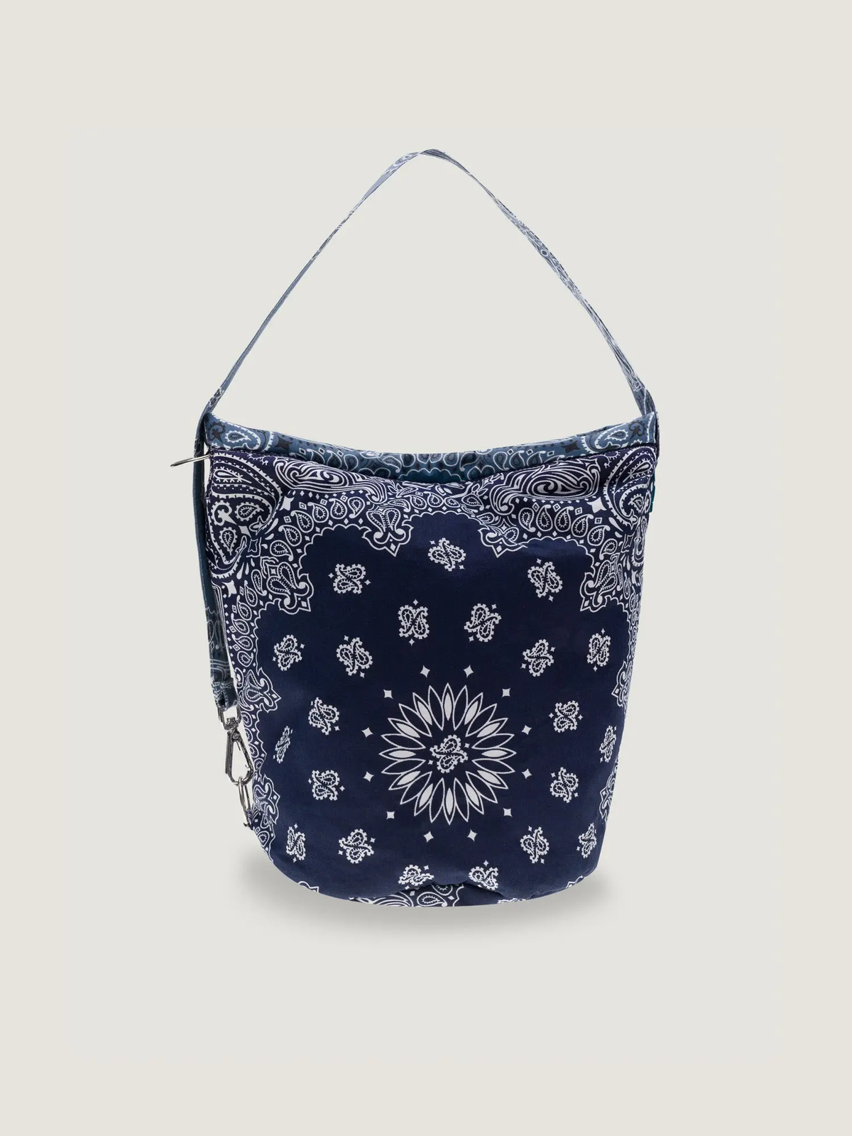 Navy bucket bag with white bandana print and adjustable shoulder strap