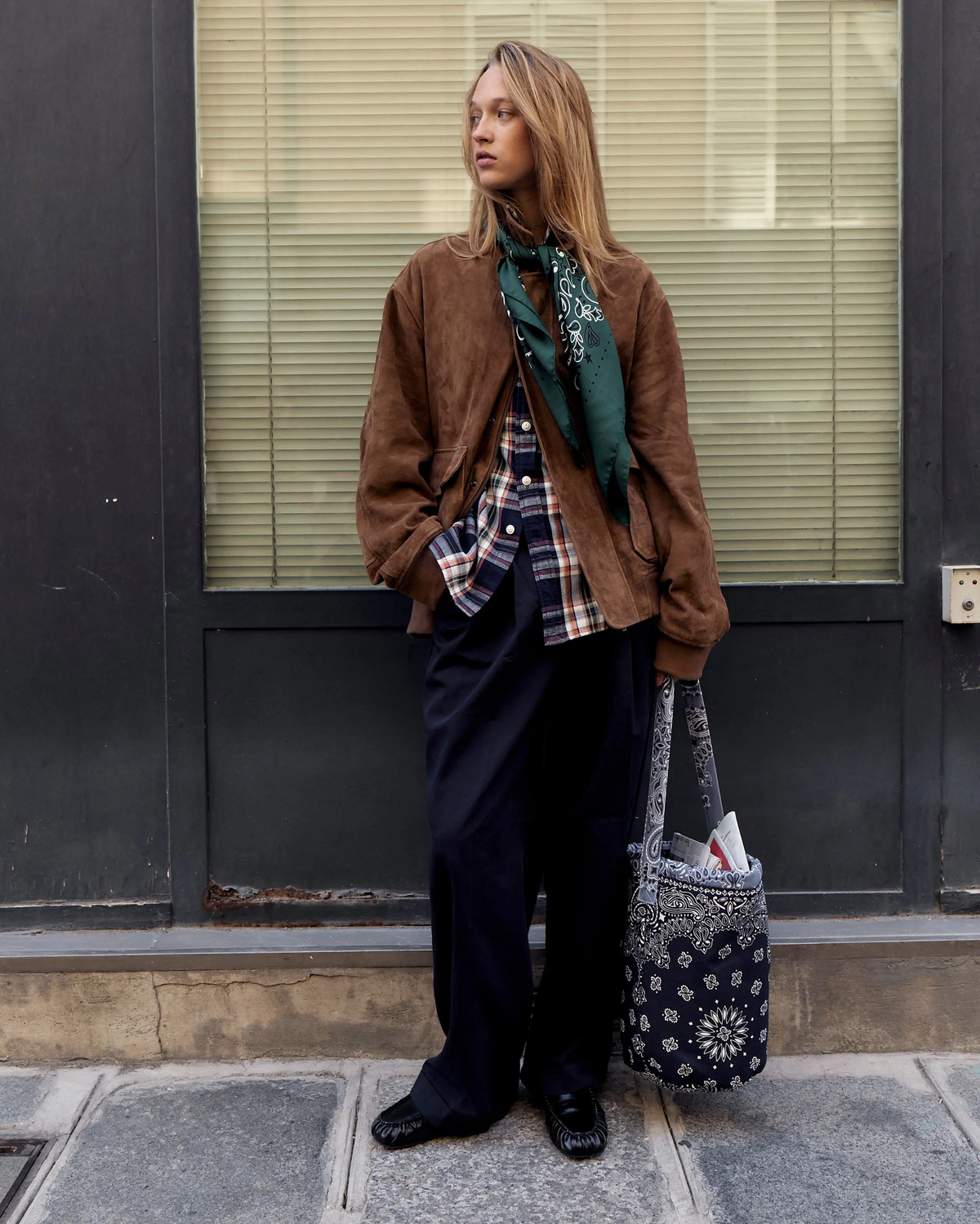 Navy bandana-print bucket bag carried by its long strap