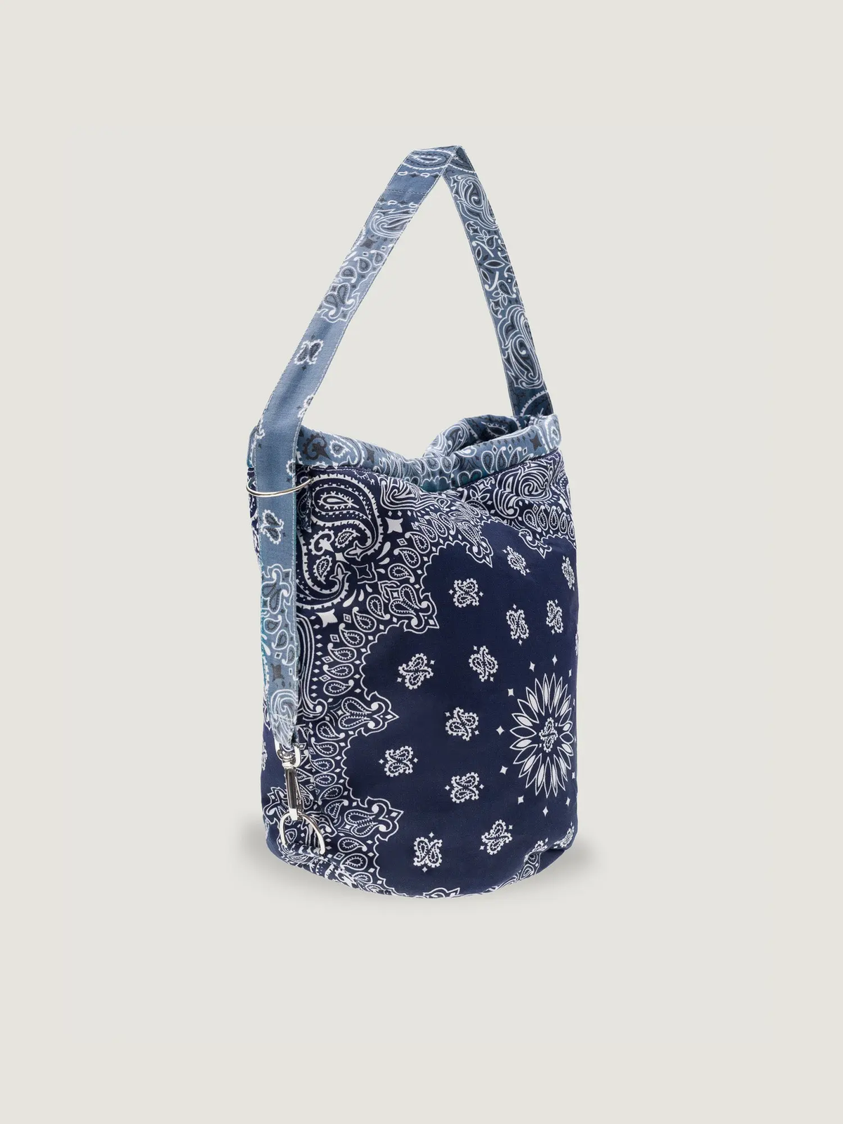 Navy bandana-print bucket bag with a long shoulder strap and cylindrical shape