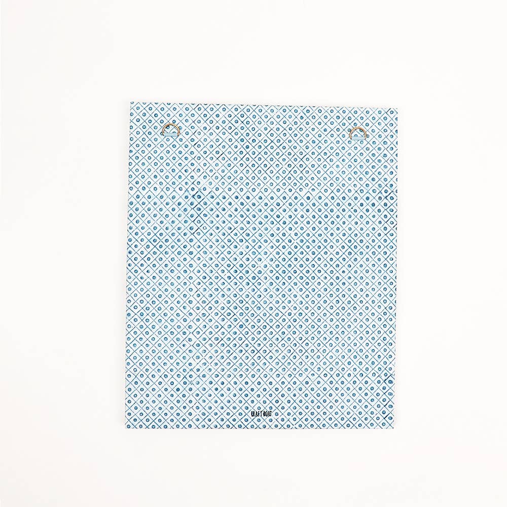 Back of blue block-printed wall picture frame with repeating trellis pattern