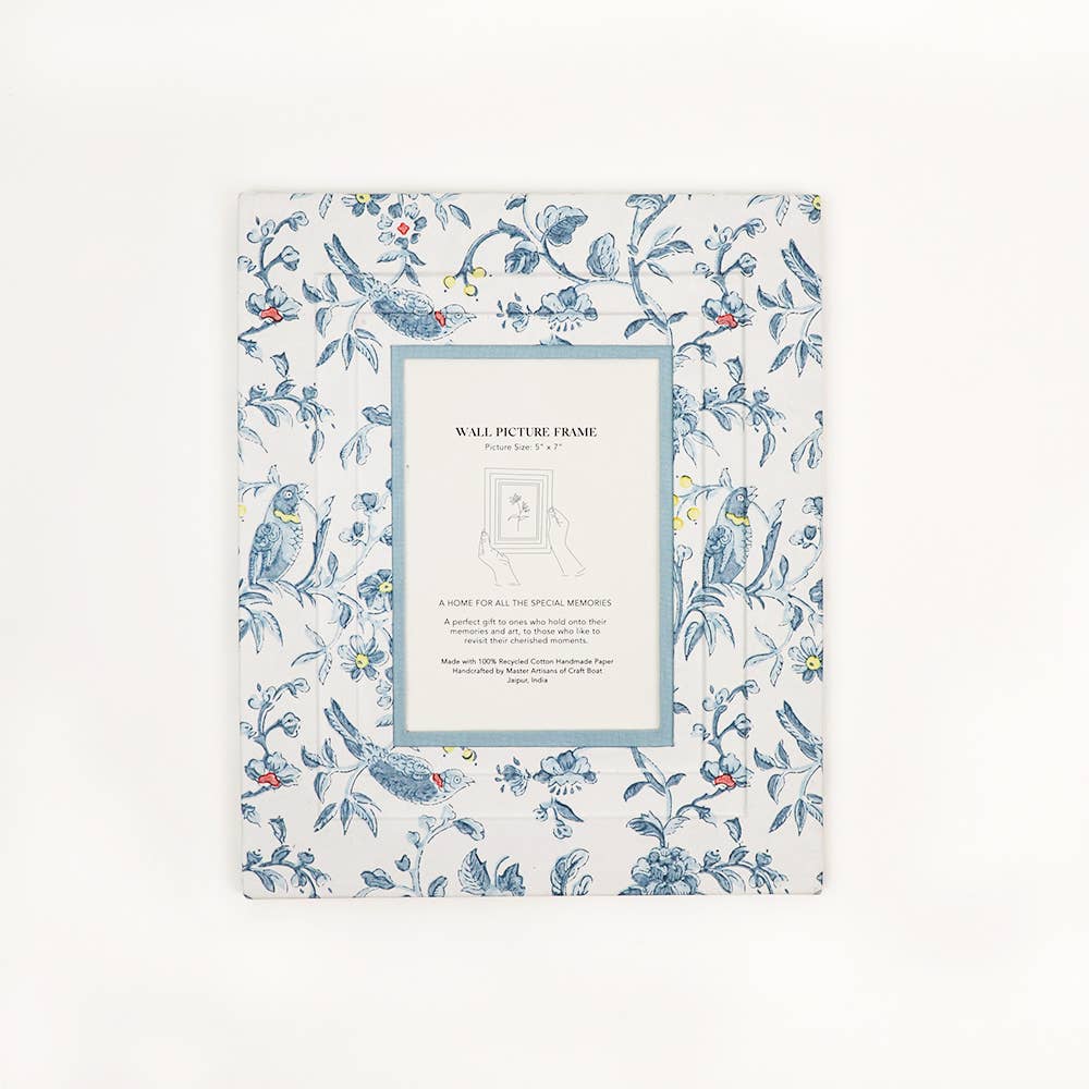 Blue block-printed wall picture frame with bird and flower design around a white mat