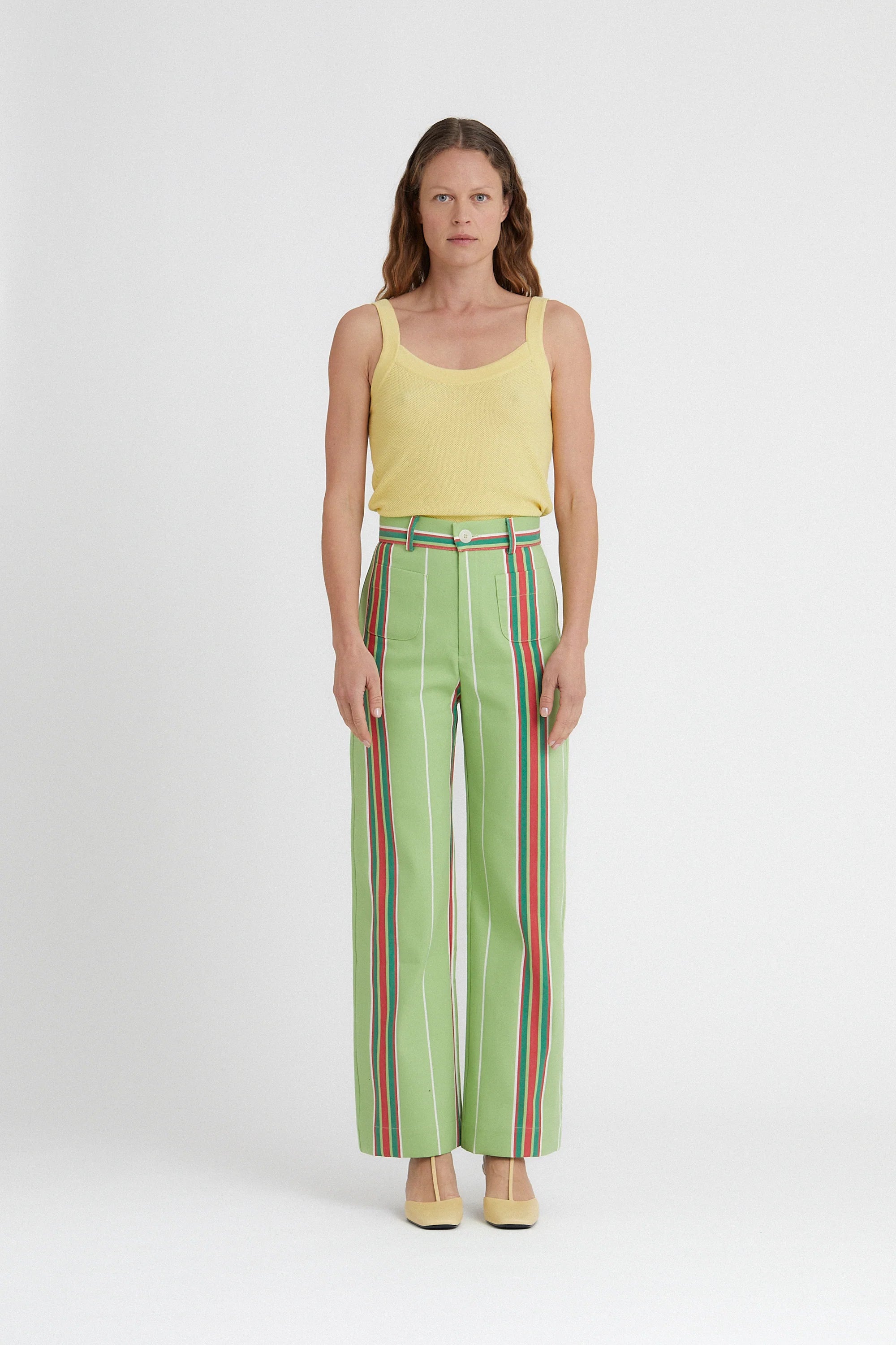 Lime green Pippi wide-leg pants with bold vertical striped trim and side pockets