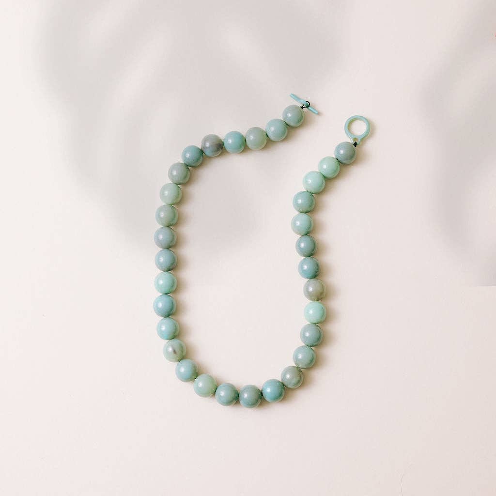 Seafoam gumball beaded necklace with round beads and open ring clasp on display