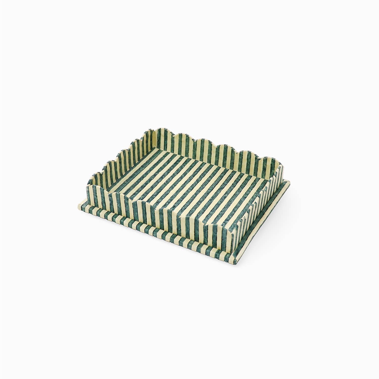 Large scalloped serving tray with striped green and white pattern from above.
