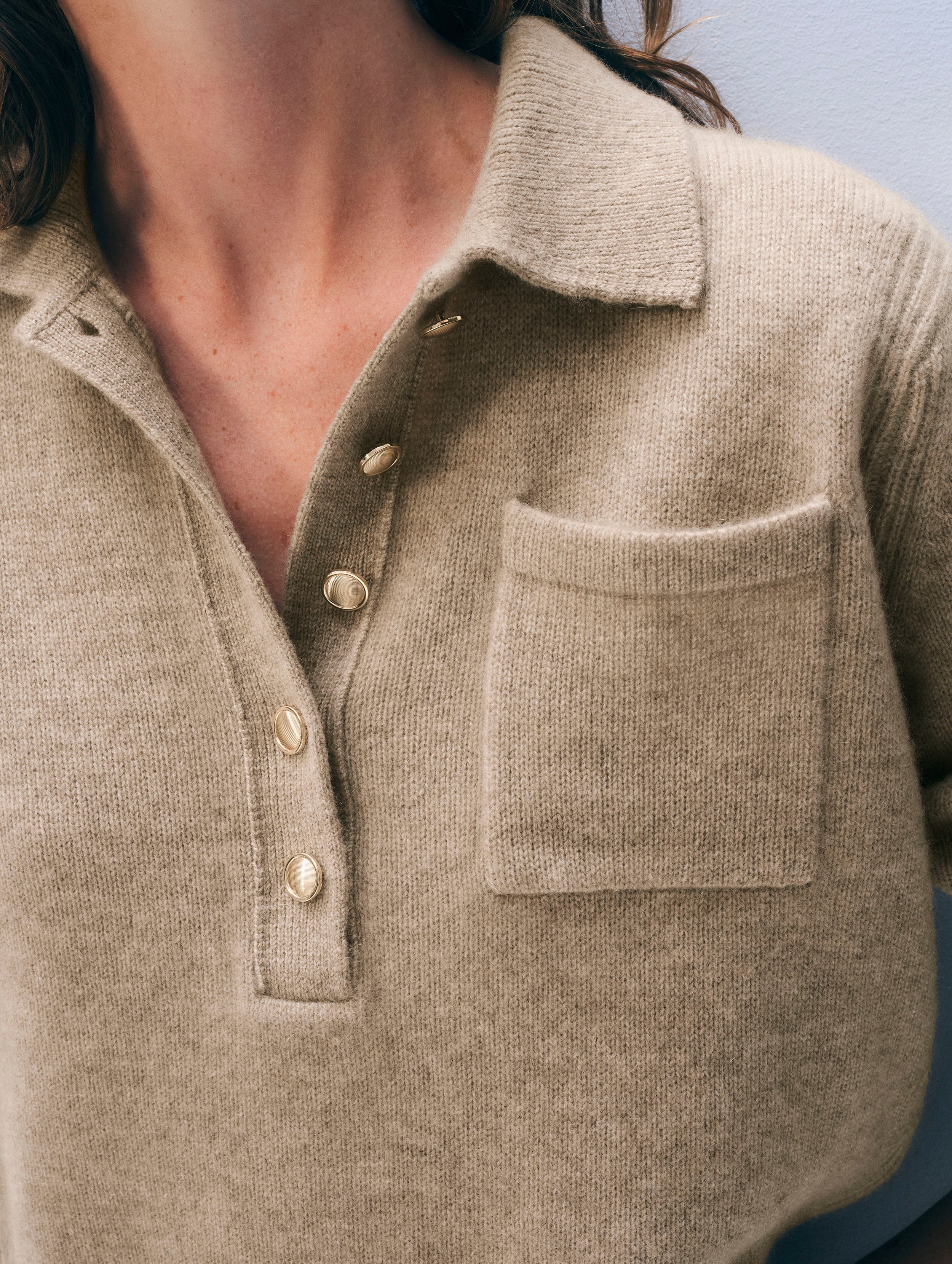 Beige cashmere polo sweater with collared neckline, gold-tone buttons, chest pocket