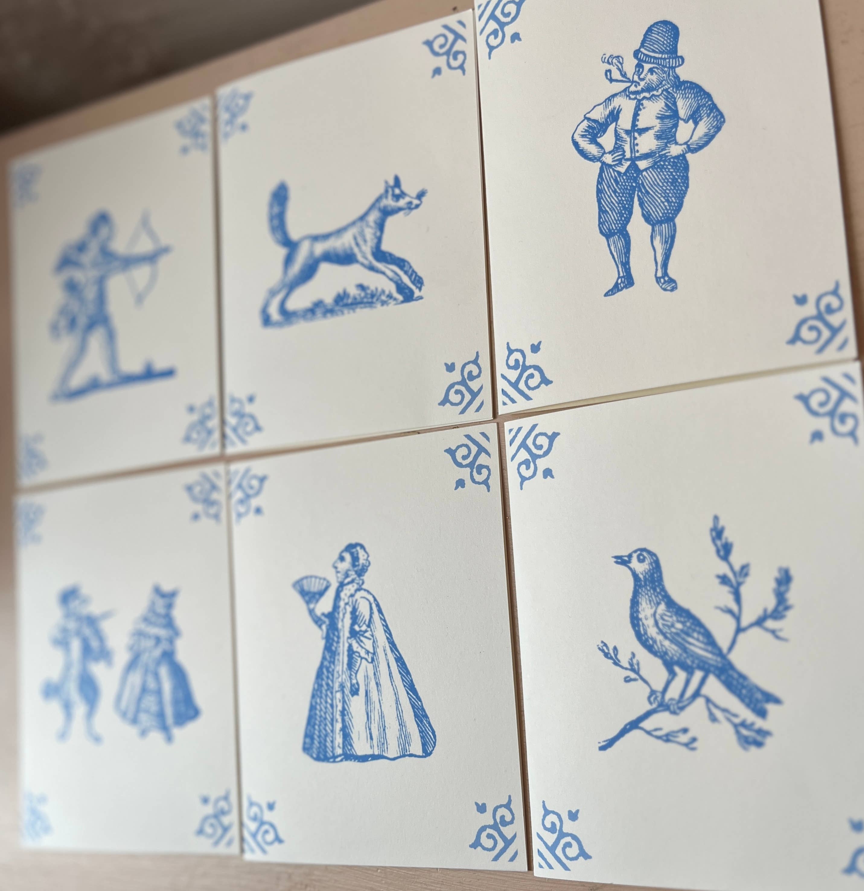 Four-card layout with blue illustrations of dog, archer, woman, and bird, corner motifs