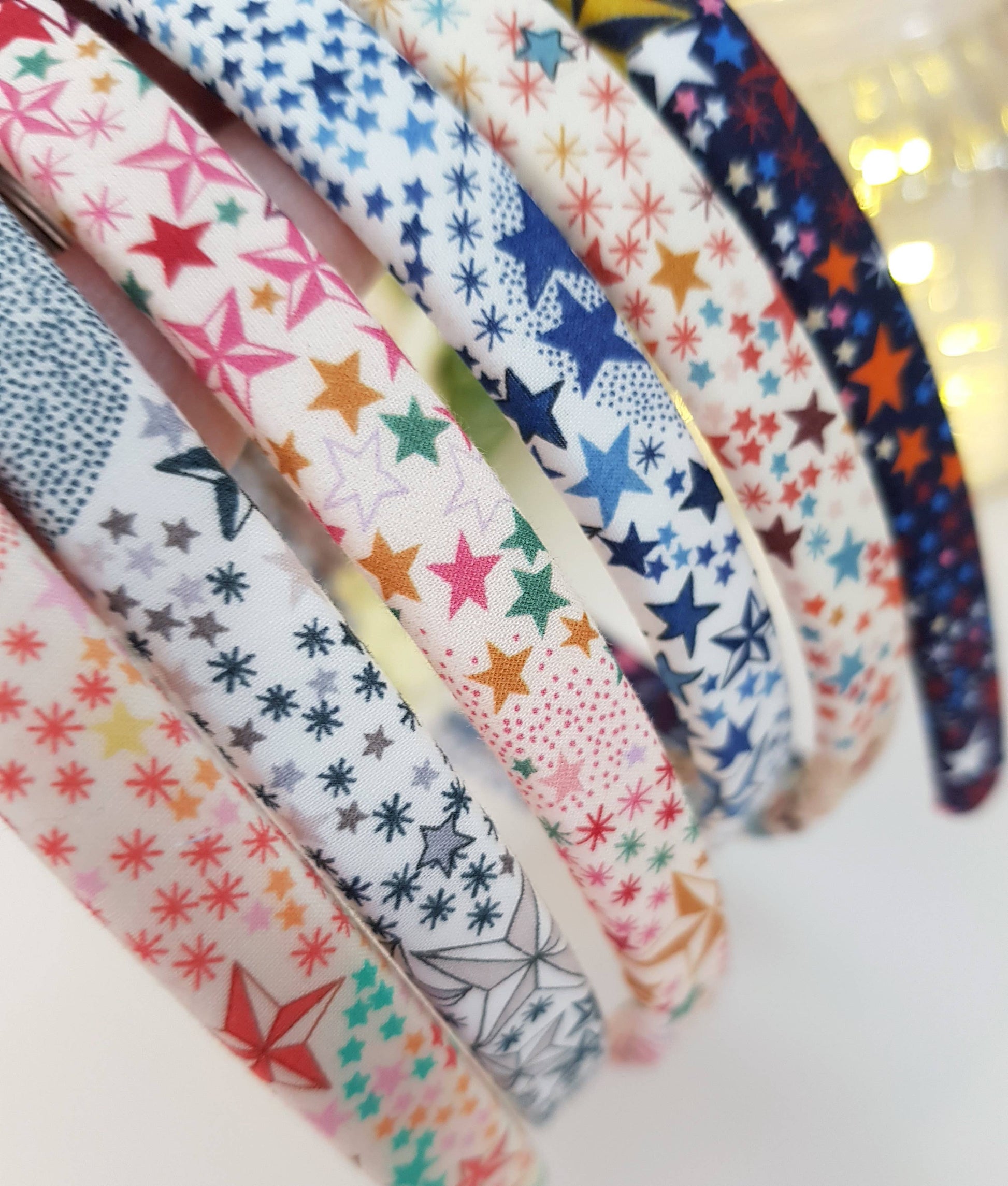Star and snowflake patterned headband fabric, multicolor on white