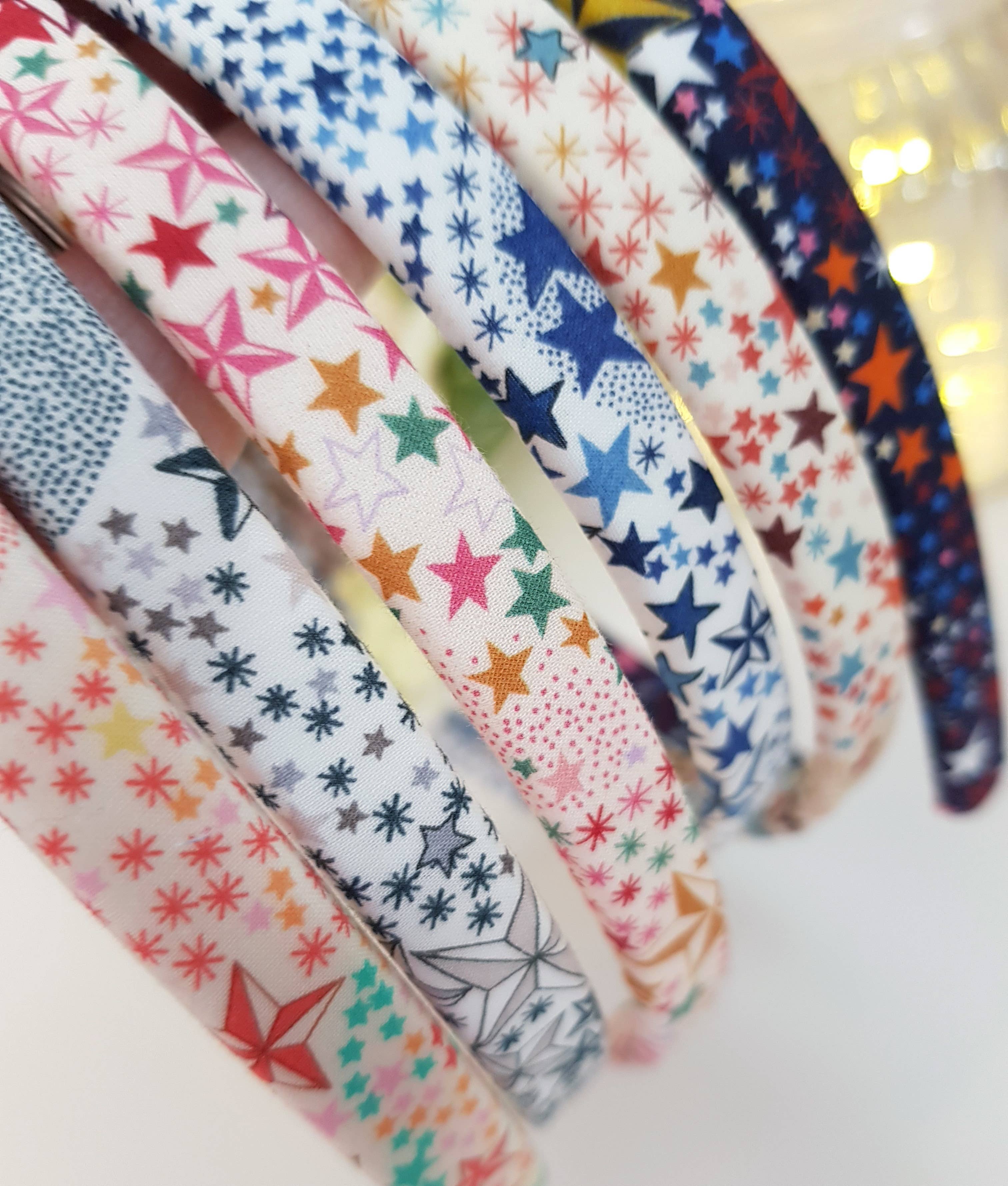 Star and snowflake patterned headband fabric, multicolor on white