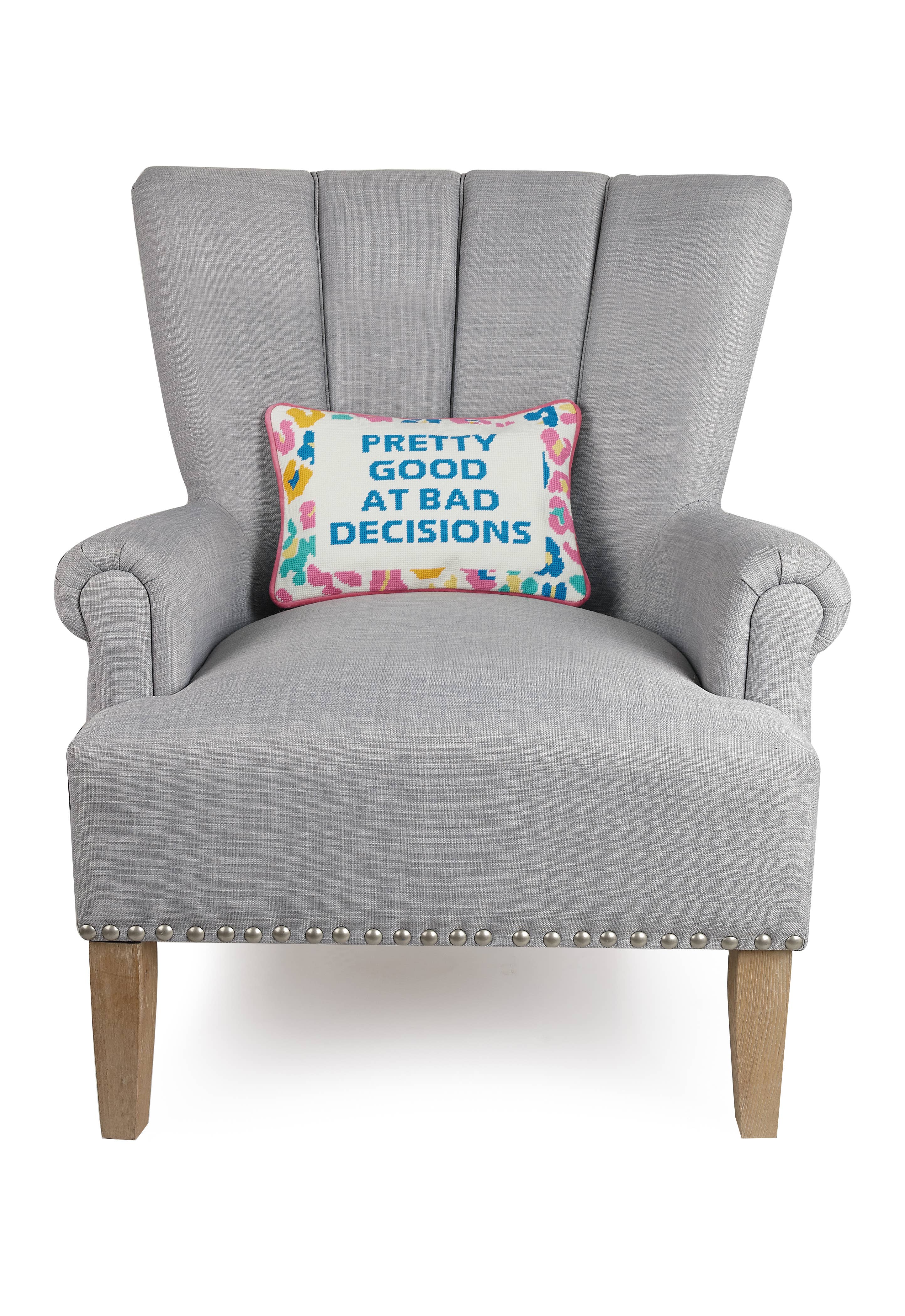 Decorative throw pillow with embroidered blue text on multicolor border