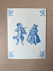 White card with blue illustration of dog musician and cat in dress, ornate corner motifs