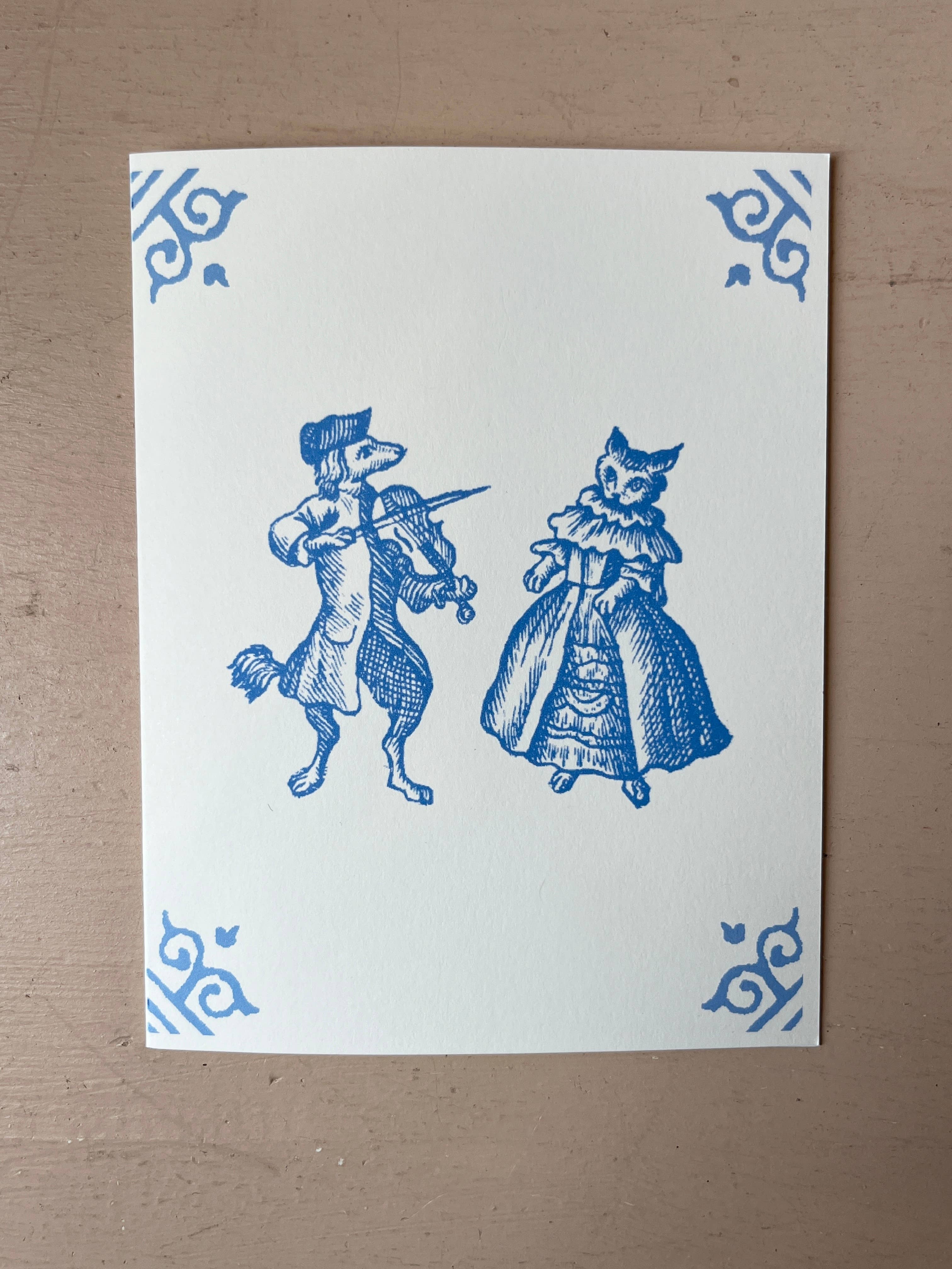 White card with blue illustration of dog musician and cat in dress, ornate corner motifs
