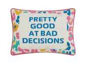 Embroidered decorative pillow with multicolor border and blue text on cream fabric