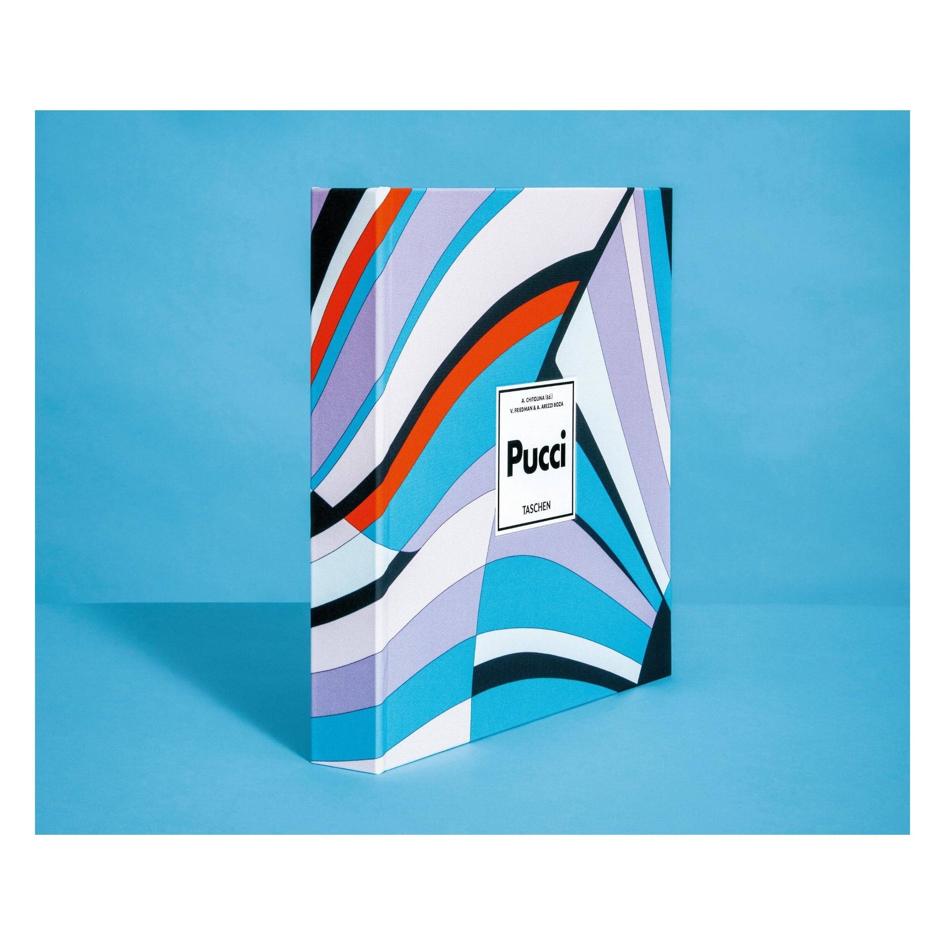 Pucci fashion book, upright view showing abstract striped cover art and logo sticker.