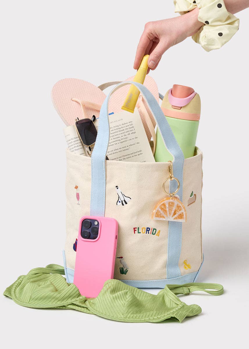 Small canvas tote bag with light blue handles and Florida icon prints, keychain charm