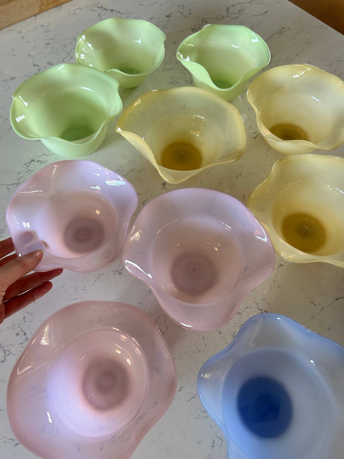 Set of glossy green ruffle bowls with fluted, scalloped rims.