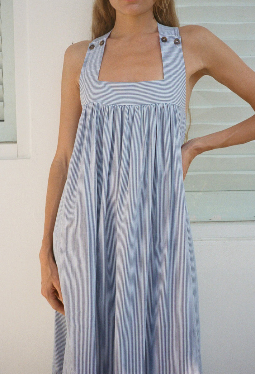 Sleeveless blue and white striped cotton dress with square neckline and buttoned straps