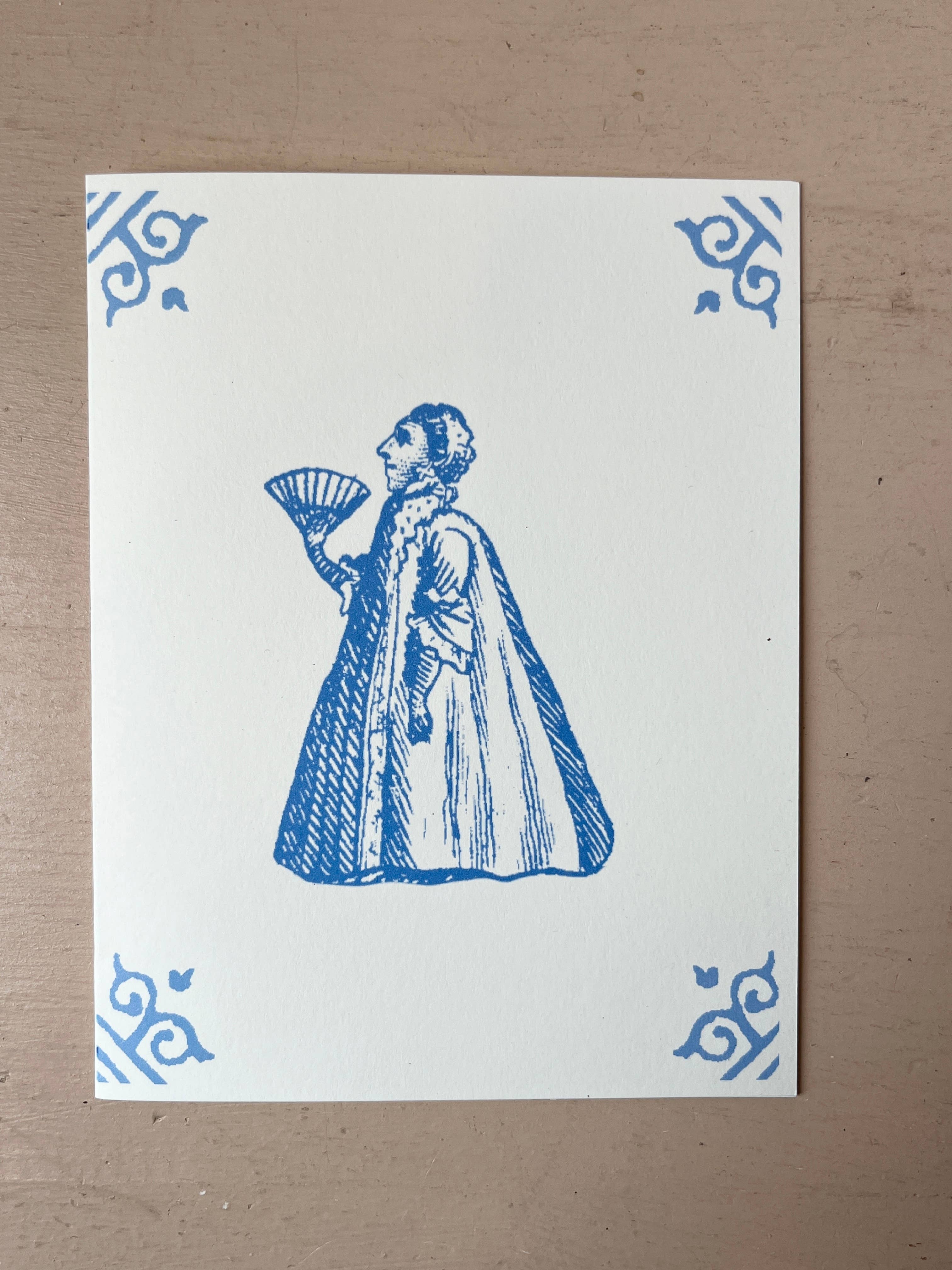 White card with blue illustration of a costumed man holding a hand-fan-like bowl, corner motifs