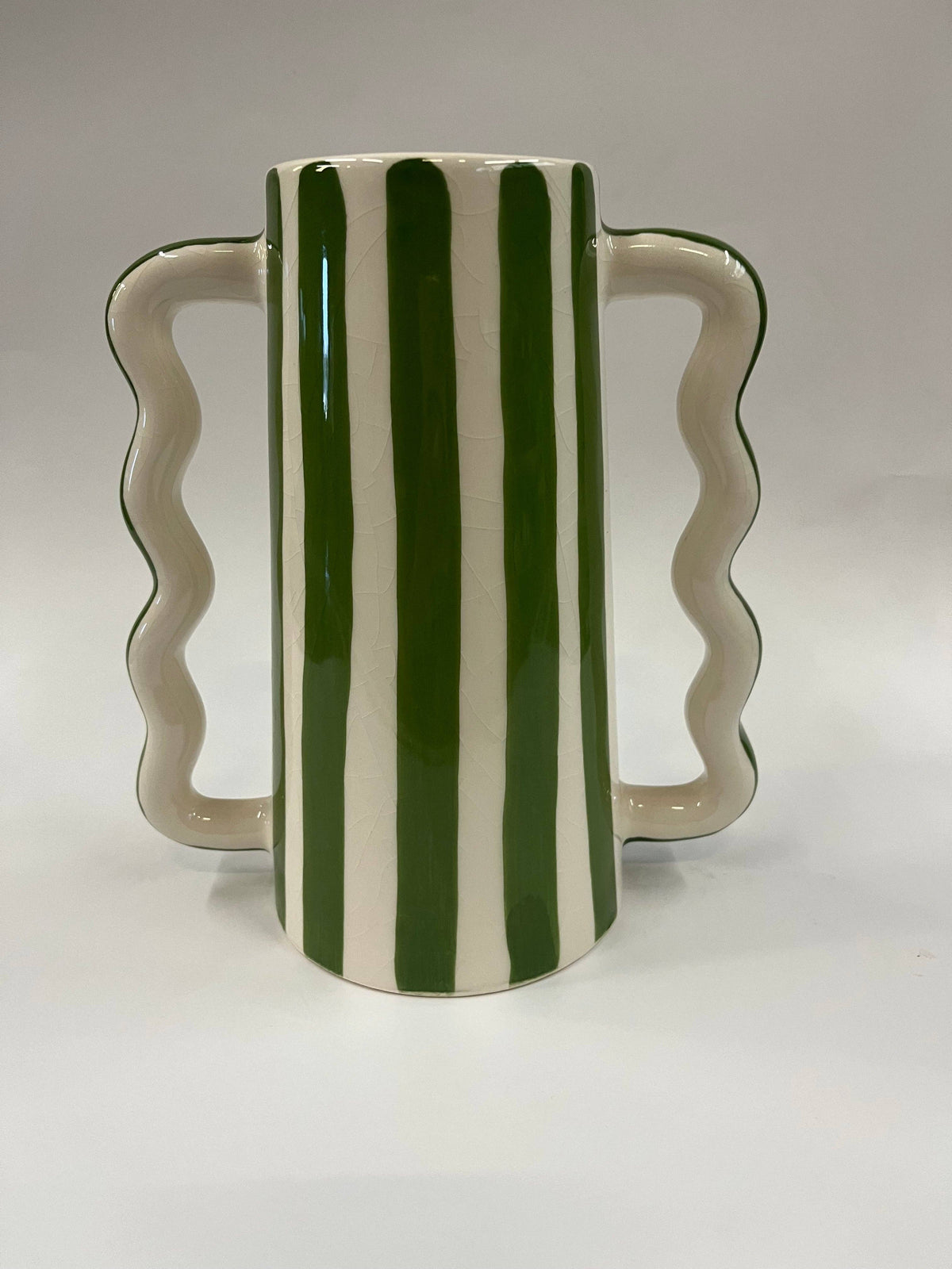 Small ceramic vase with wavy side handles and green vertical stripe pattern