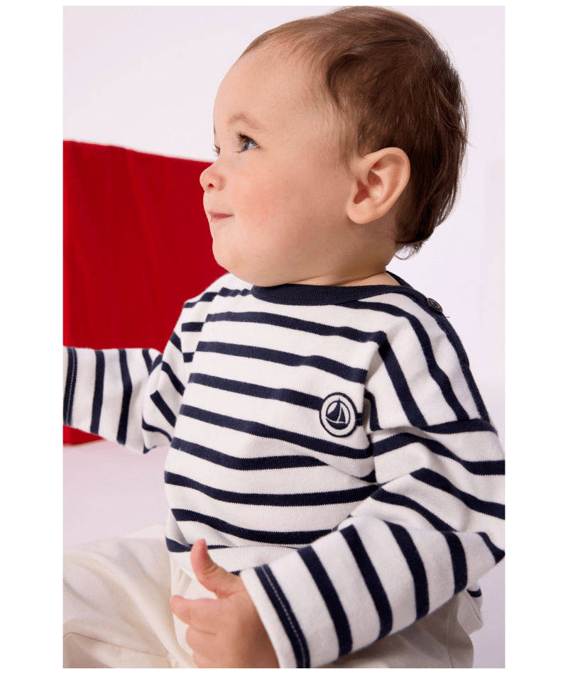 Infant long sleeve Breton top on model, navy and white stripes, crew neck, chest badge