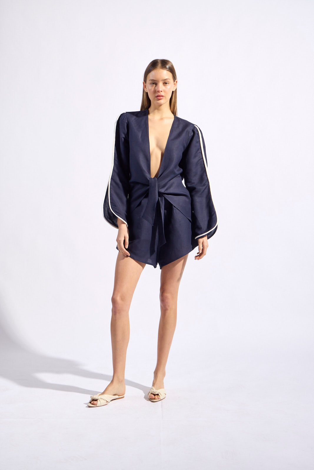 Navy linen shorts with white-trim waistband and front pleats, short length
