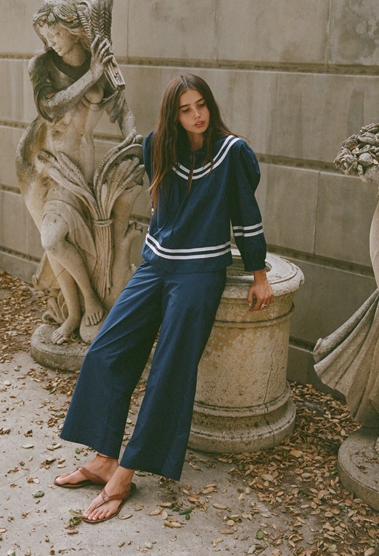 Navy long-sleeve top with white striped sailor collar and drawstring bow
