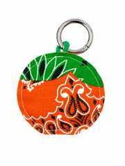 Round orange and green patterned fabric key ring with metal loop