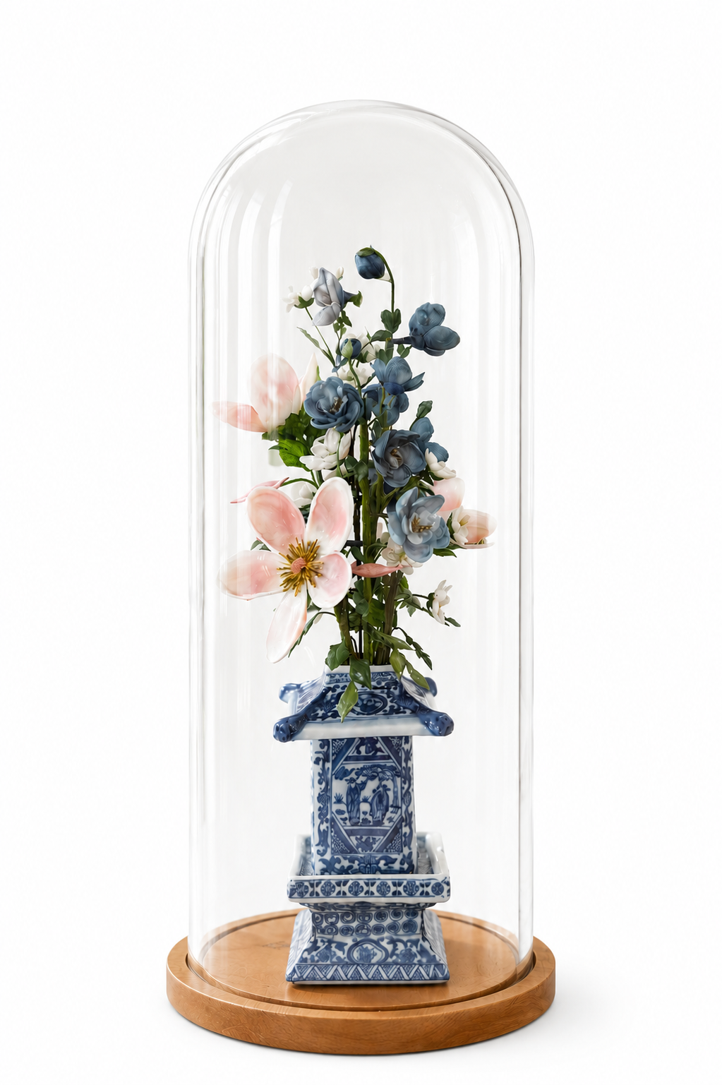 Blue floral arrangement in blue ceramic pot under clear glass dome