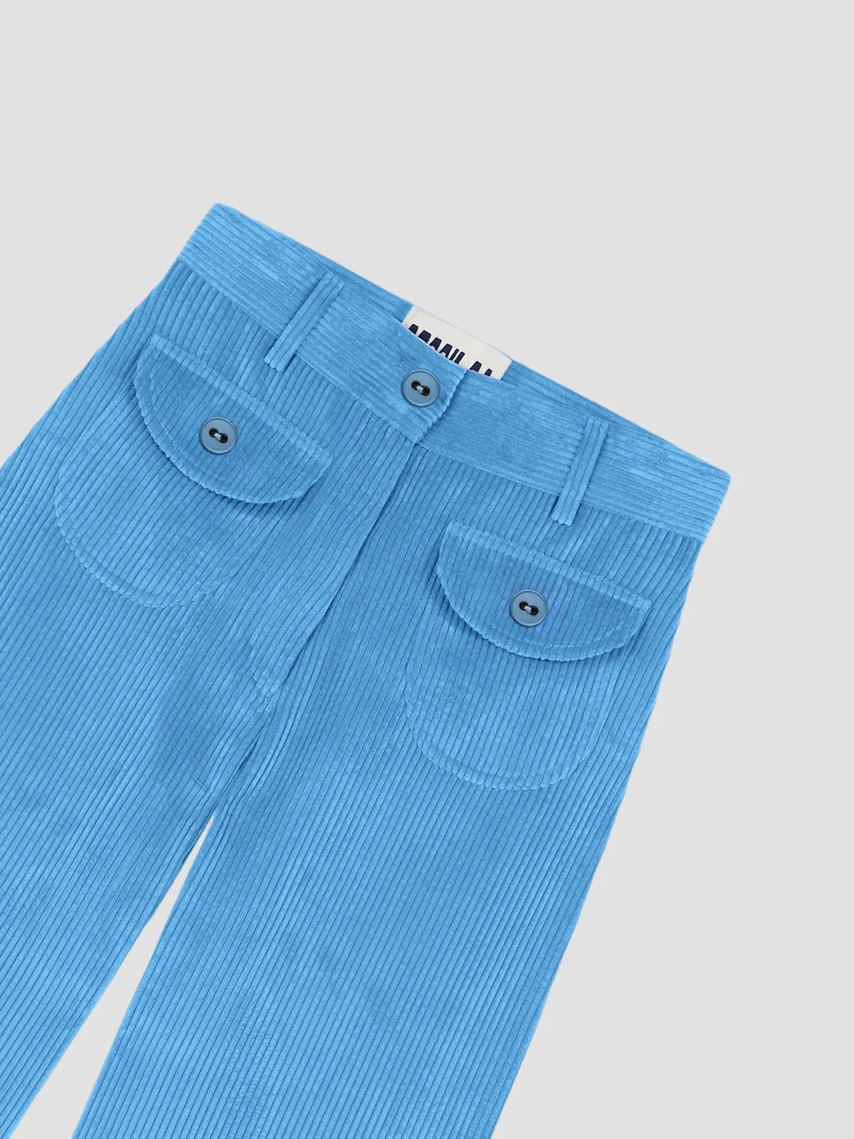 Light blue pants close-up with waistband, button fly, and flap patch pockets