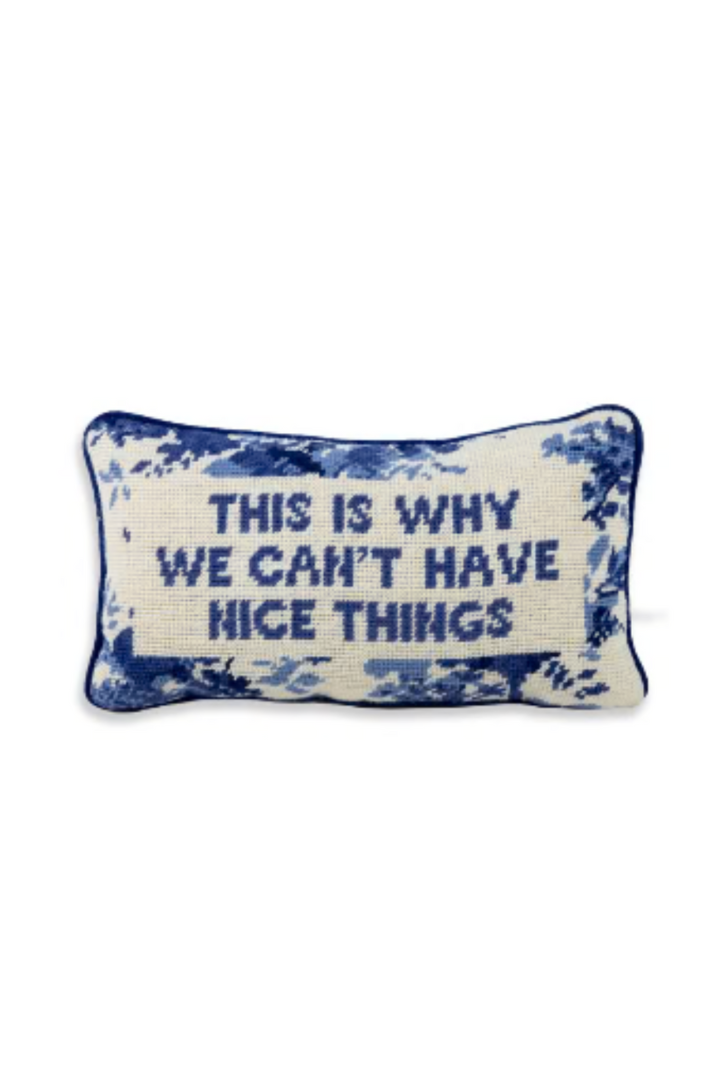 Blue-and-cream lumbar pillow with “This is why we can’t have nice things” text