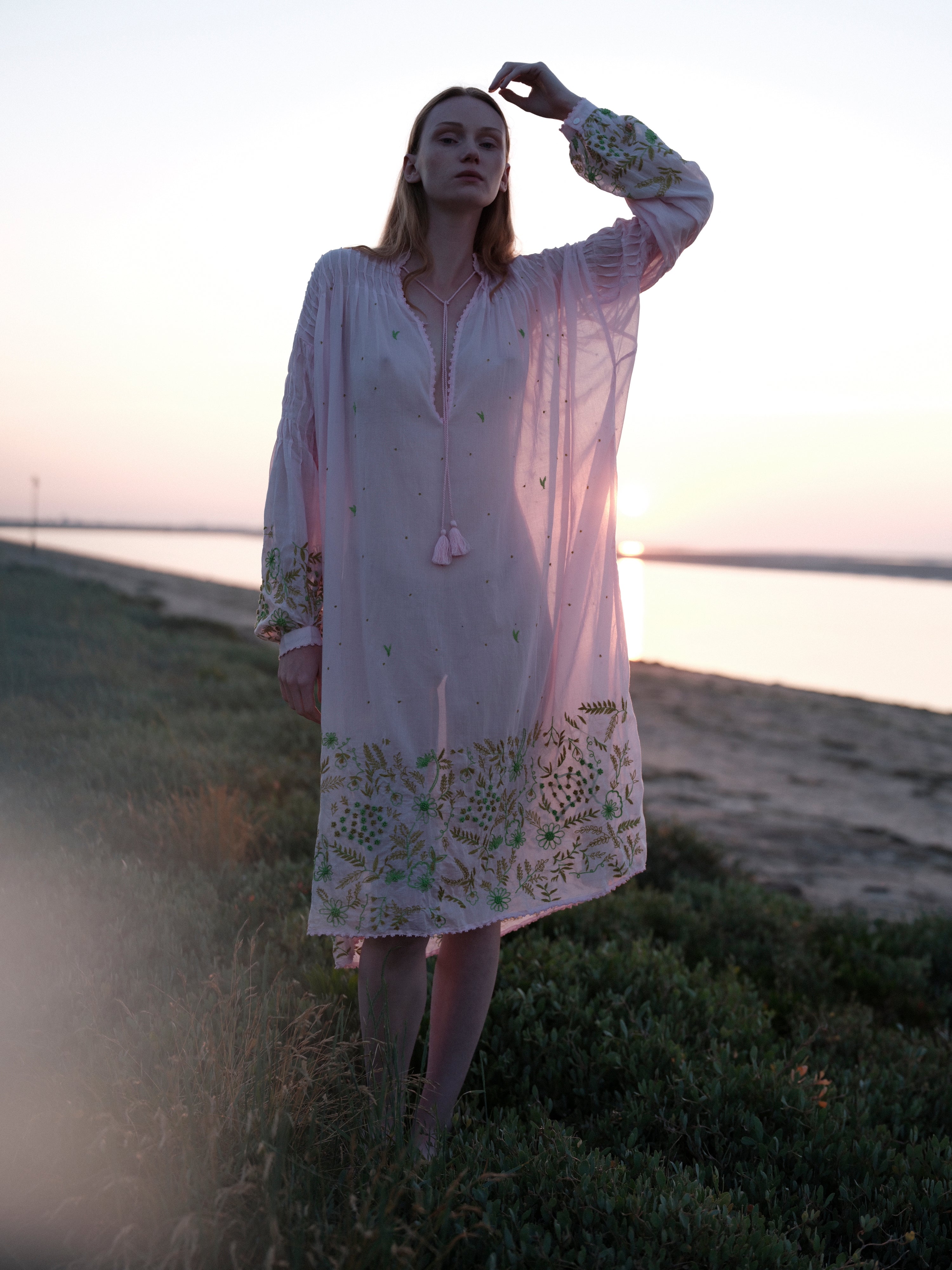 Embroidered midi dress with V-neck and tassel, long sleeves, floral hem border on model