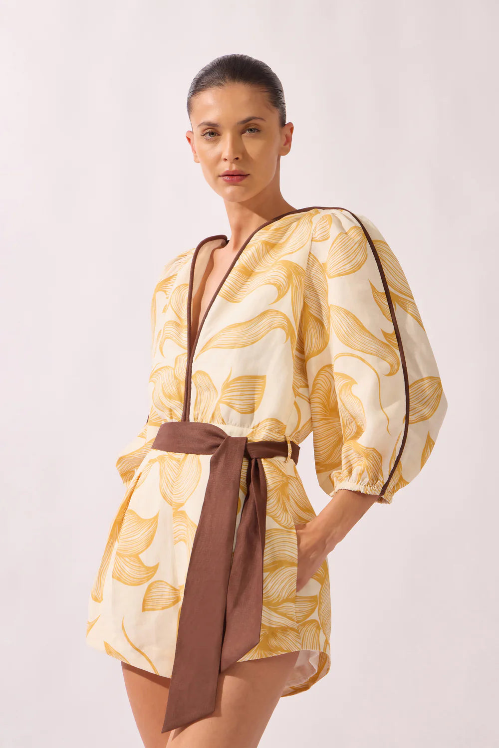 Foliage-print playsuit with balloon sleeves and dark waist tie belt, worn off-shoulder look