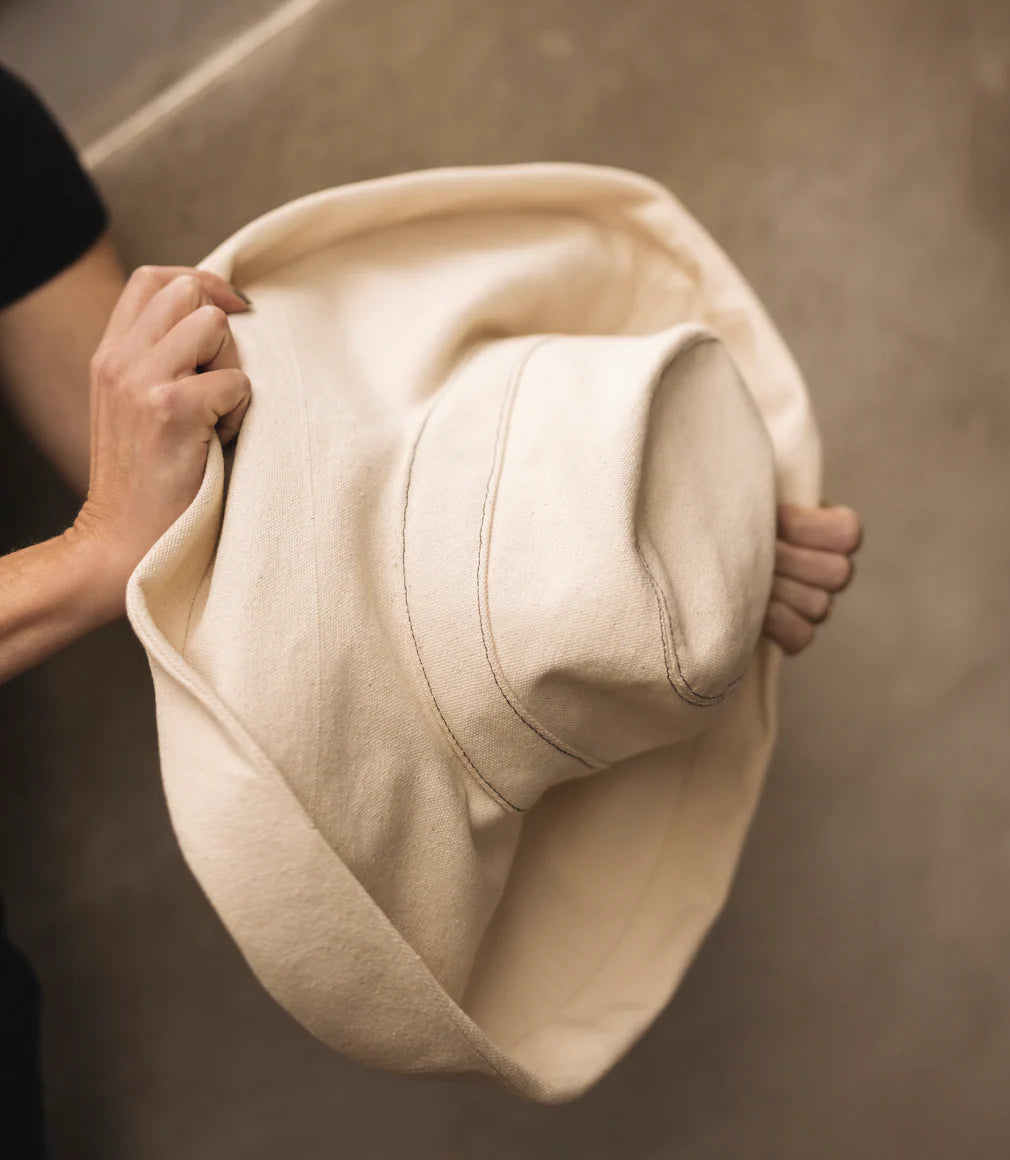 Light beige bucket hat close-up, curved brim and side stitch detail