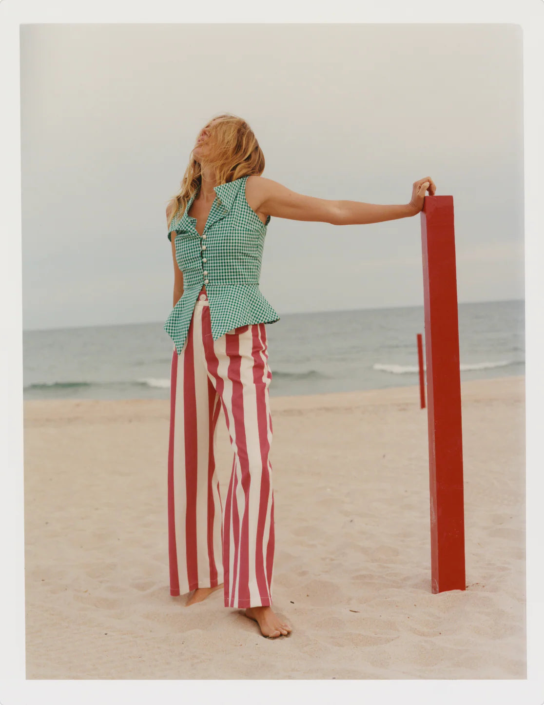Red and white striped wide-leg pants worn high-waist, with front pockets