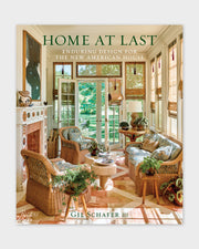 Architecture book cover with HOME AT LAST title text and warm interior photo
