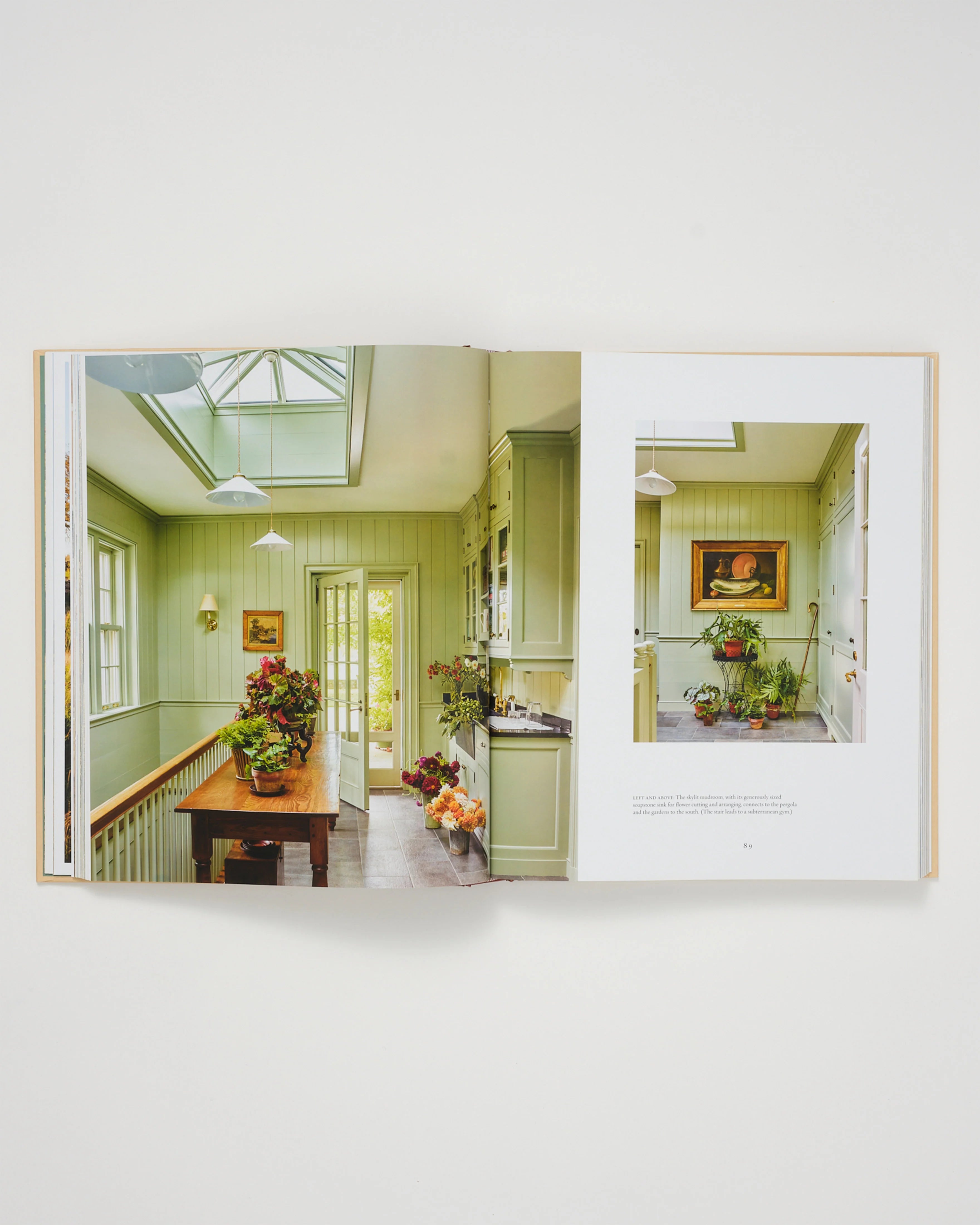 Architecture book open spread with interior photos of dining room and kitchen