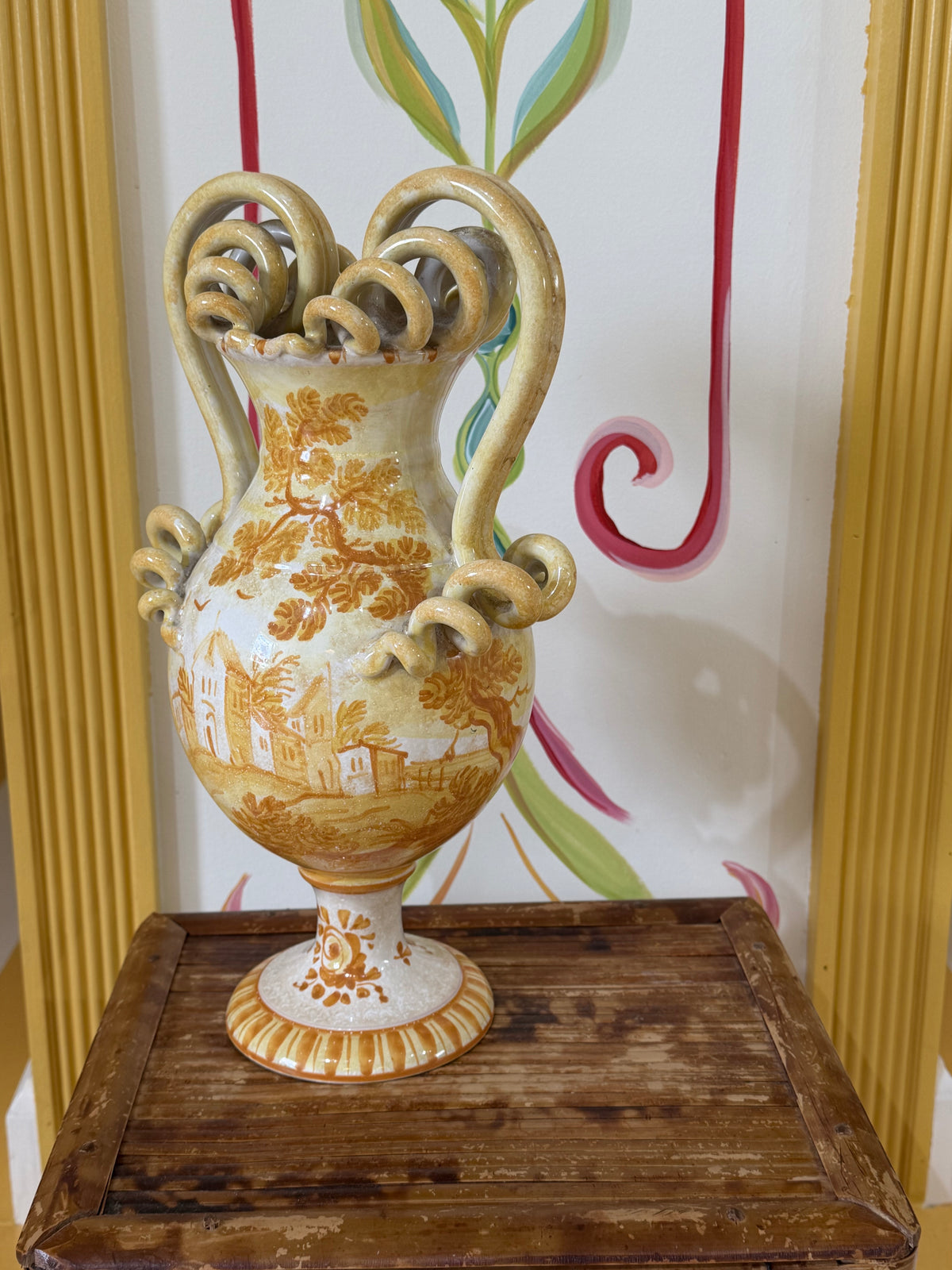 Maiolica ceramic urn with serpent handles, painted landscape scenes and gold accents.