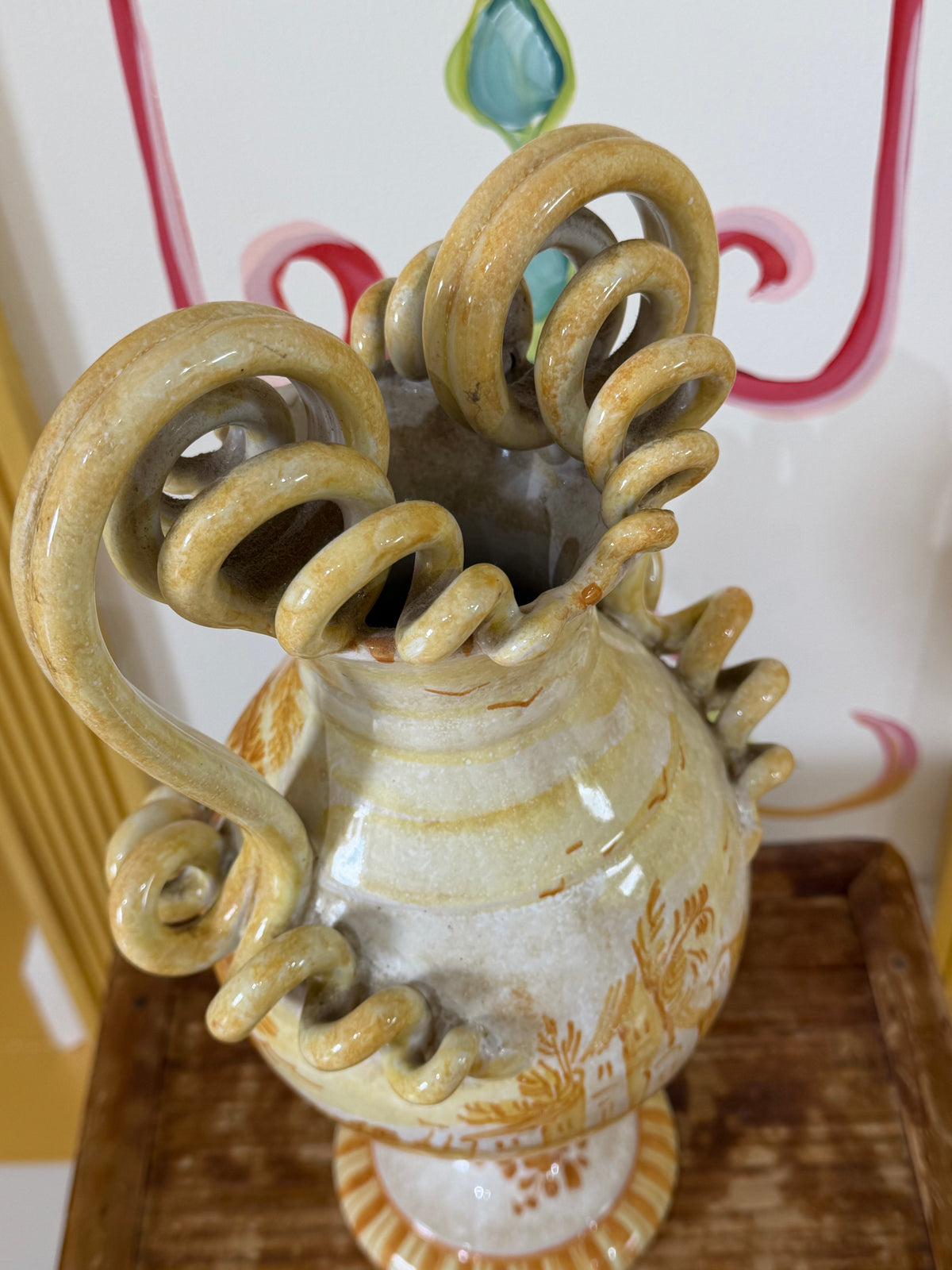 Maiolica ceramic urn with coiled serpent handles, gold and white painted details.