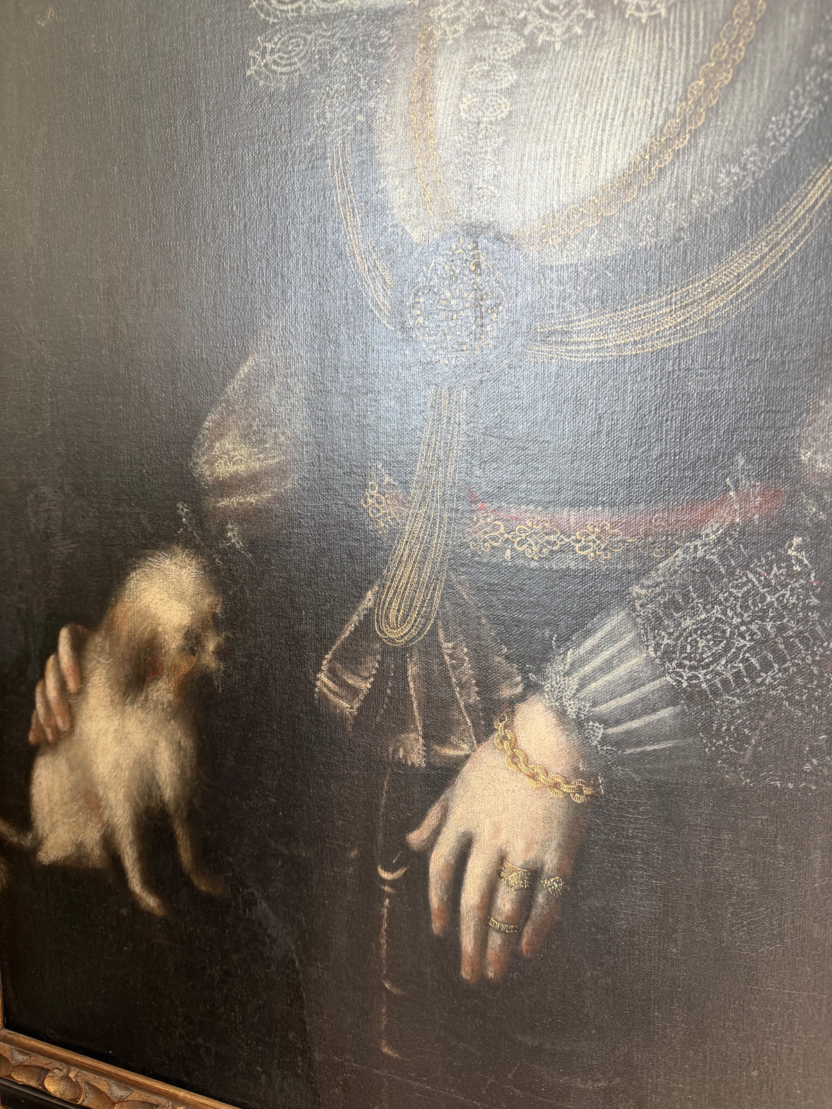 Portrait detail of a noblewoman's lace ruff collar, jeweled necklace, and embroidered sleeves