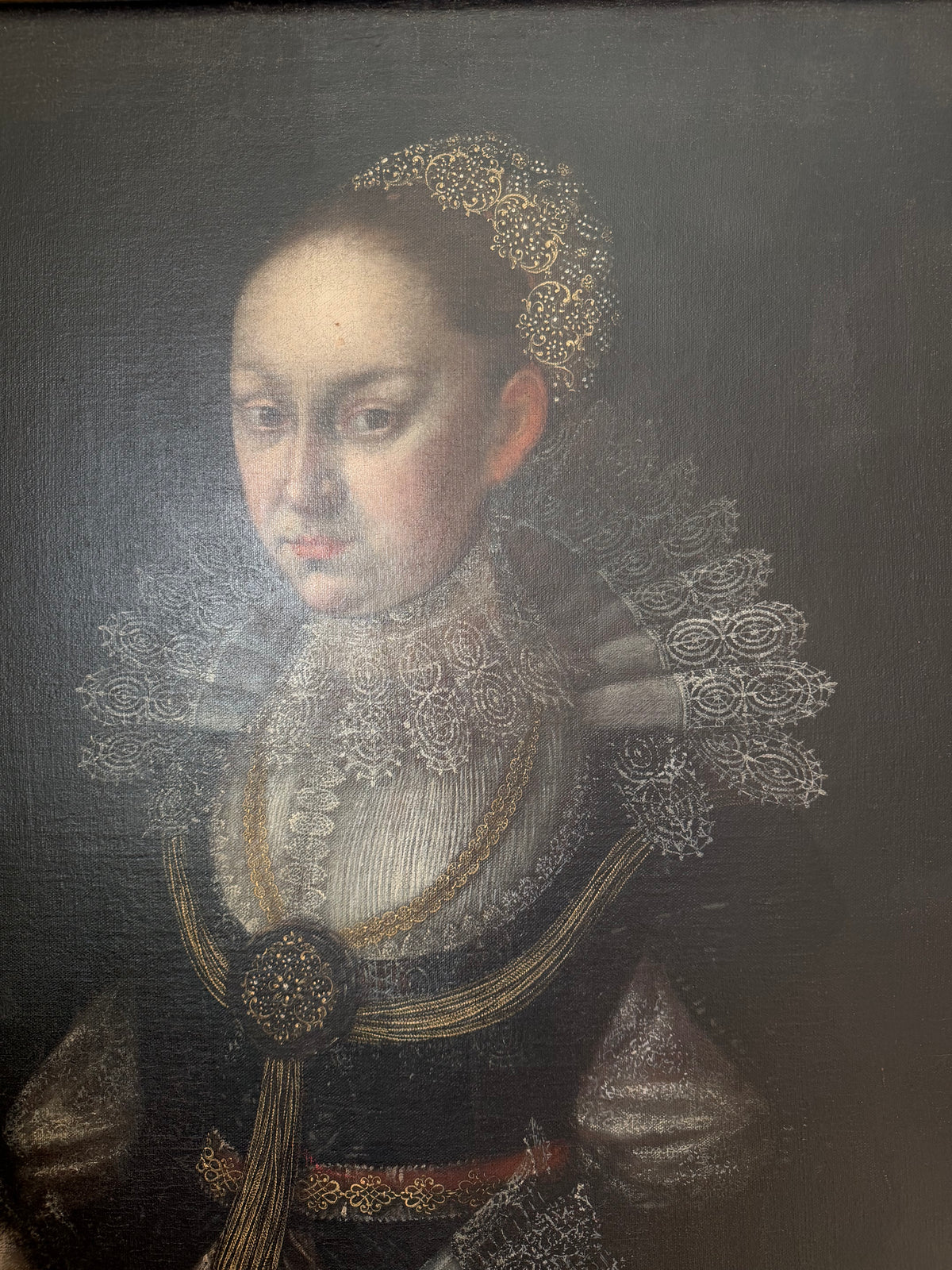 Portrait of a noblewoman with lace ruff collar, gold trim, and ornate head headdress