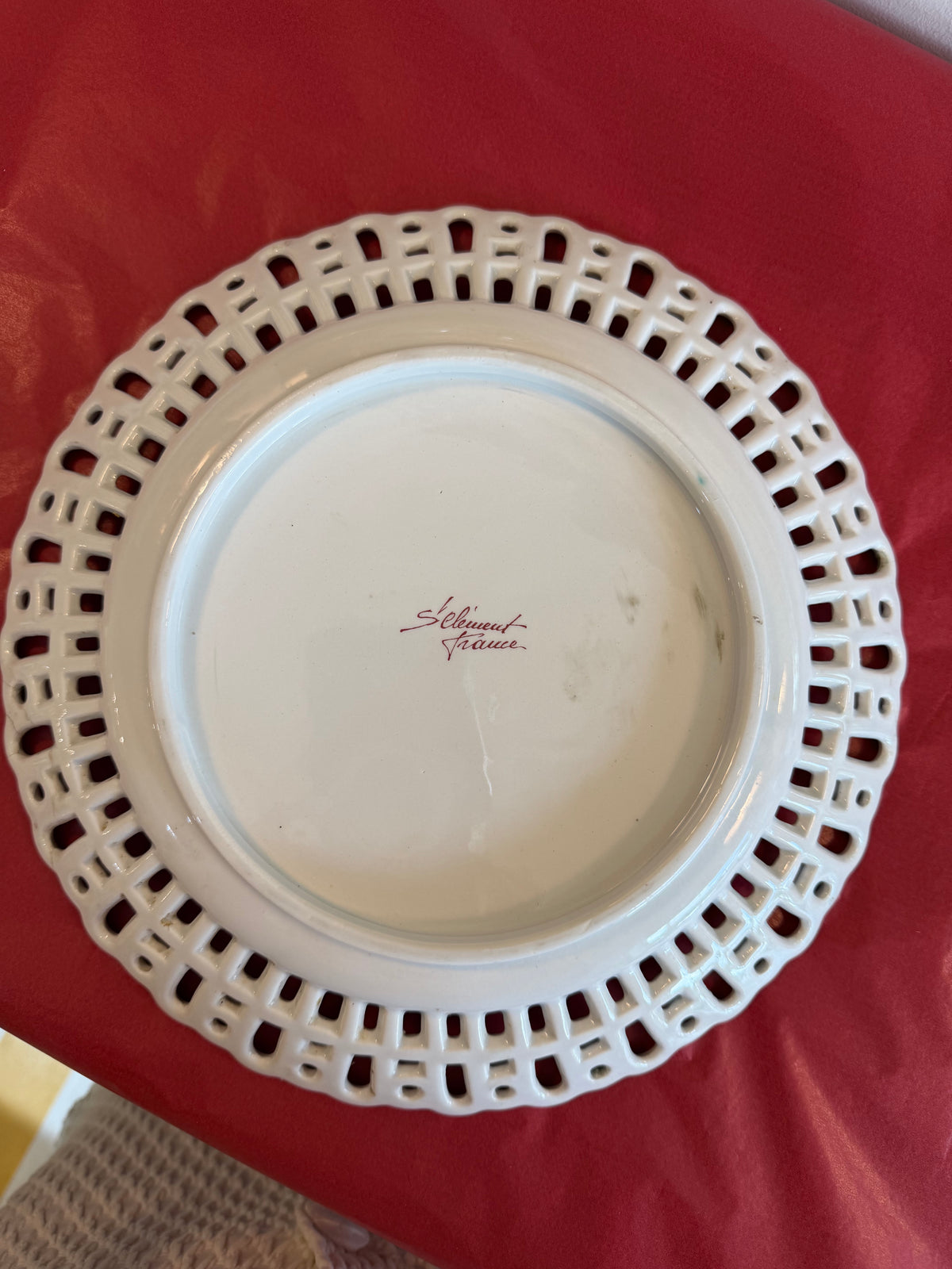 Reticulated faience plate underside with brand stamp