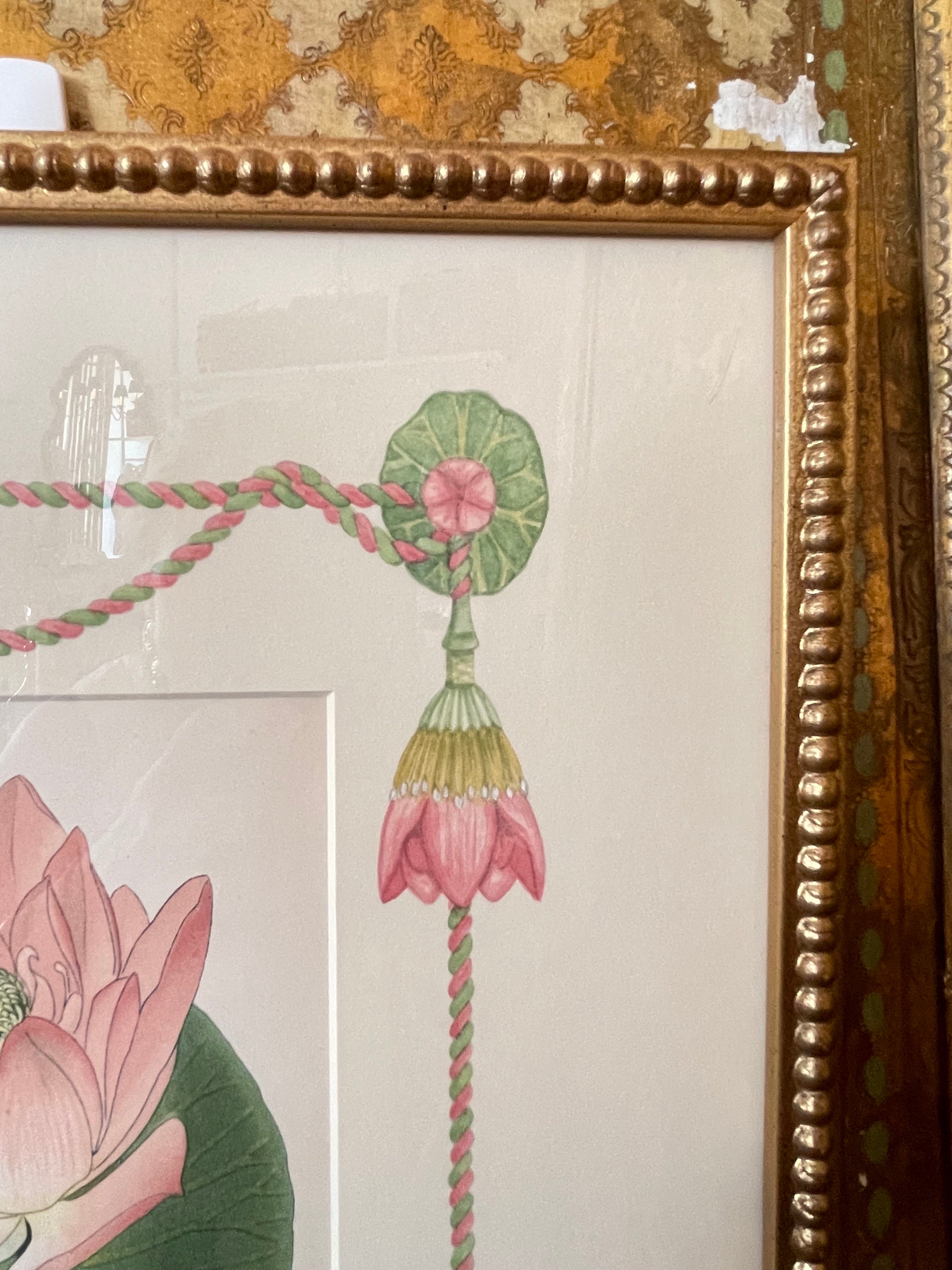 Framed botanical print detail with green vase and pink flower pendant in border