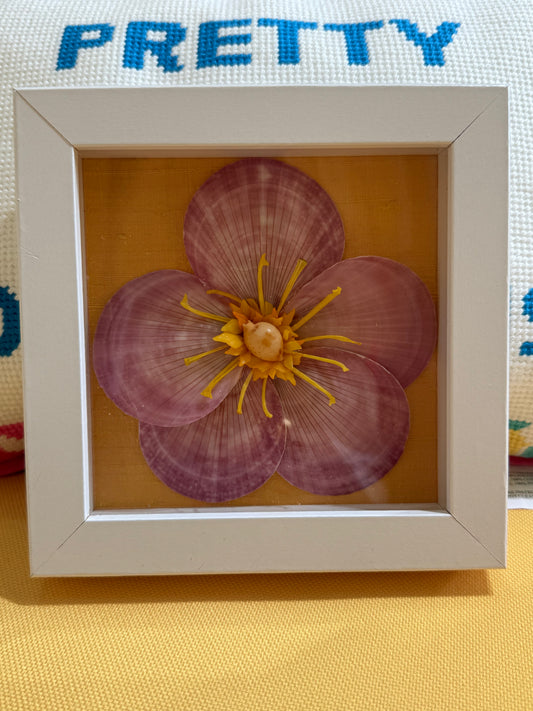 Small framed shell flower artwork with pink and yellow petals in white square frame