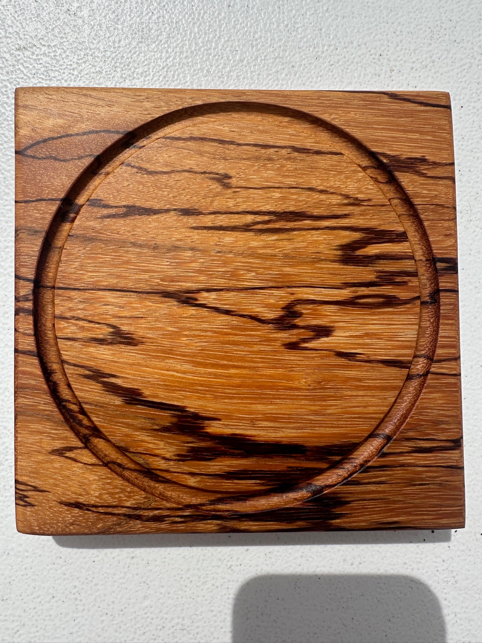 Marblewood citrus cutting board with round citrus inlay, natural wood grain