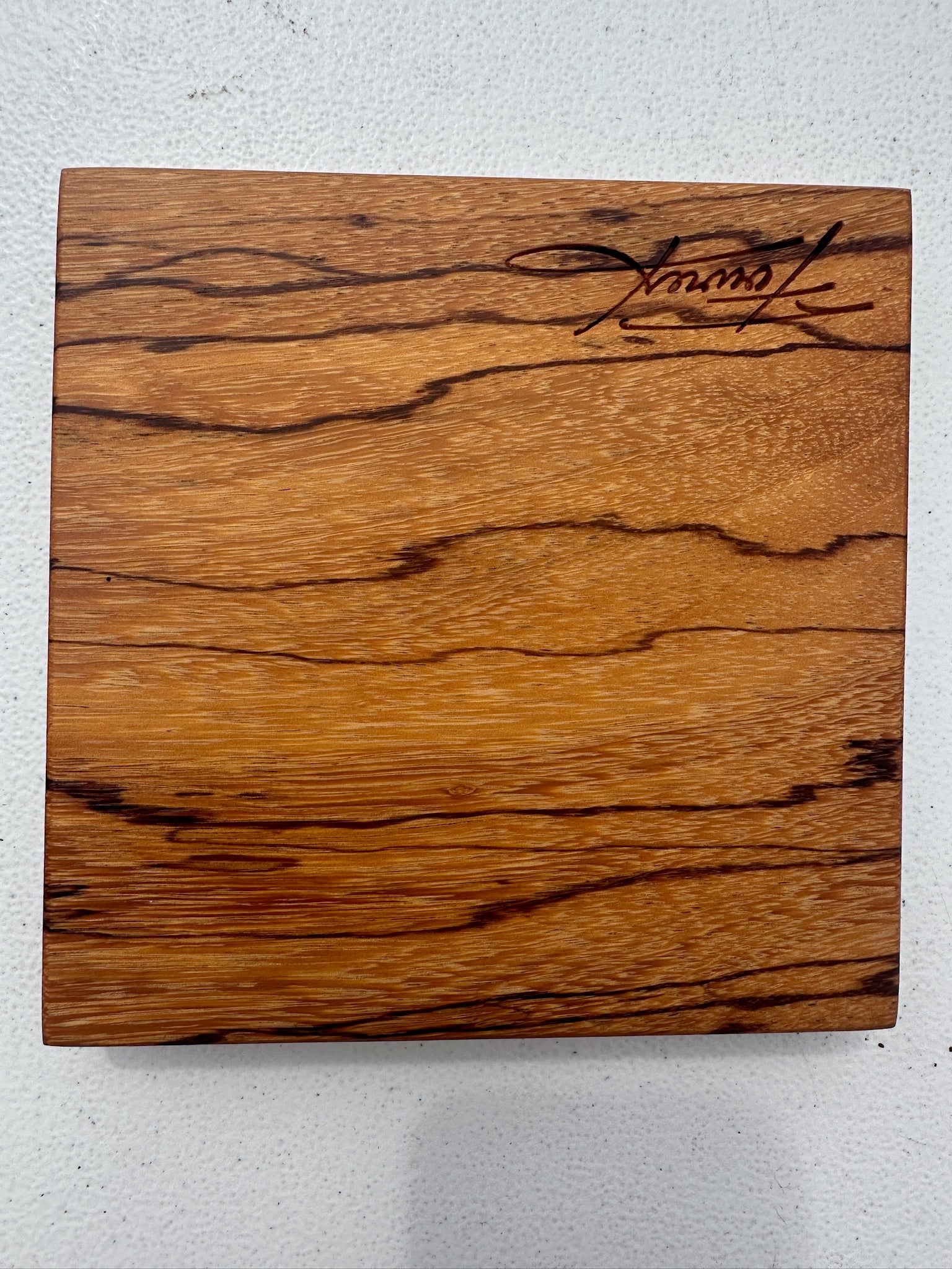 Marblewood citrus cutting board with engraved script, natural wood grain