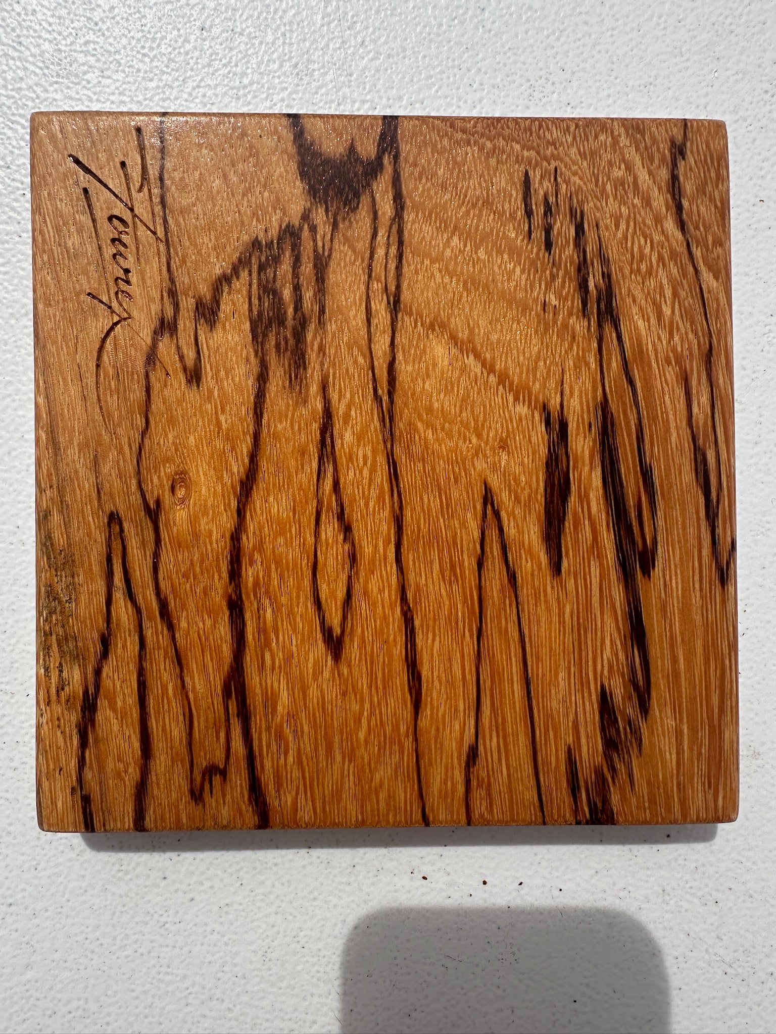 Marblewood dresser caddy front panel with rich tan color and dark knotty grain