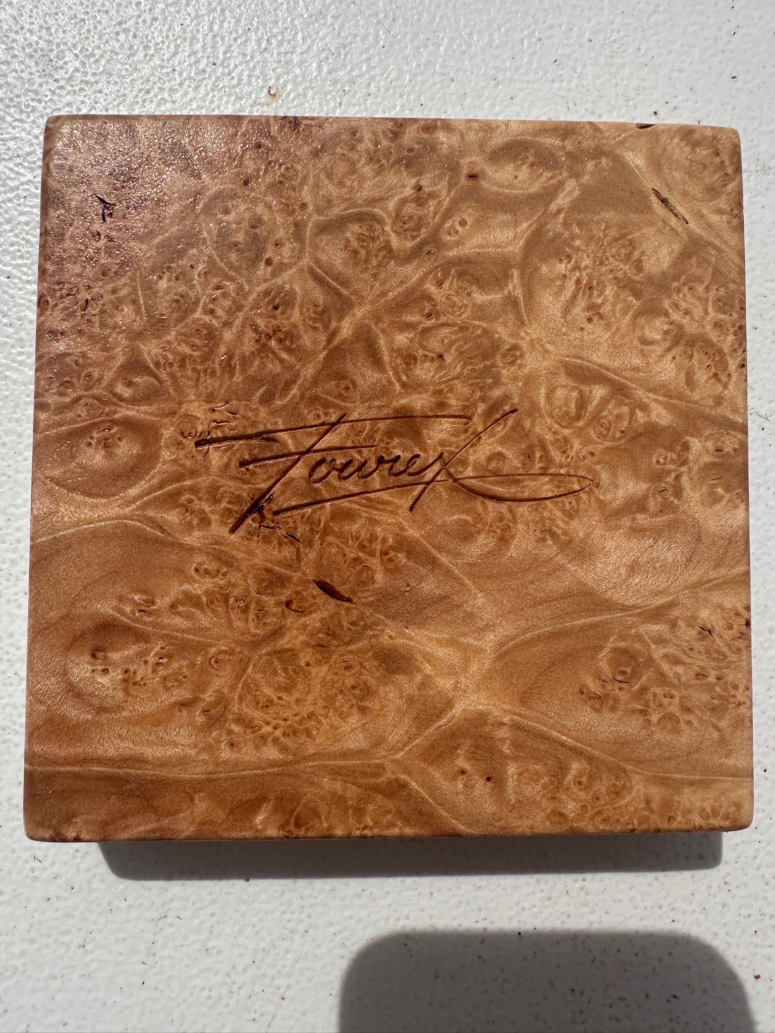 Square burlwood dish with etched signature and swirling grain, warm brown finish