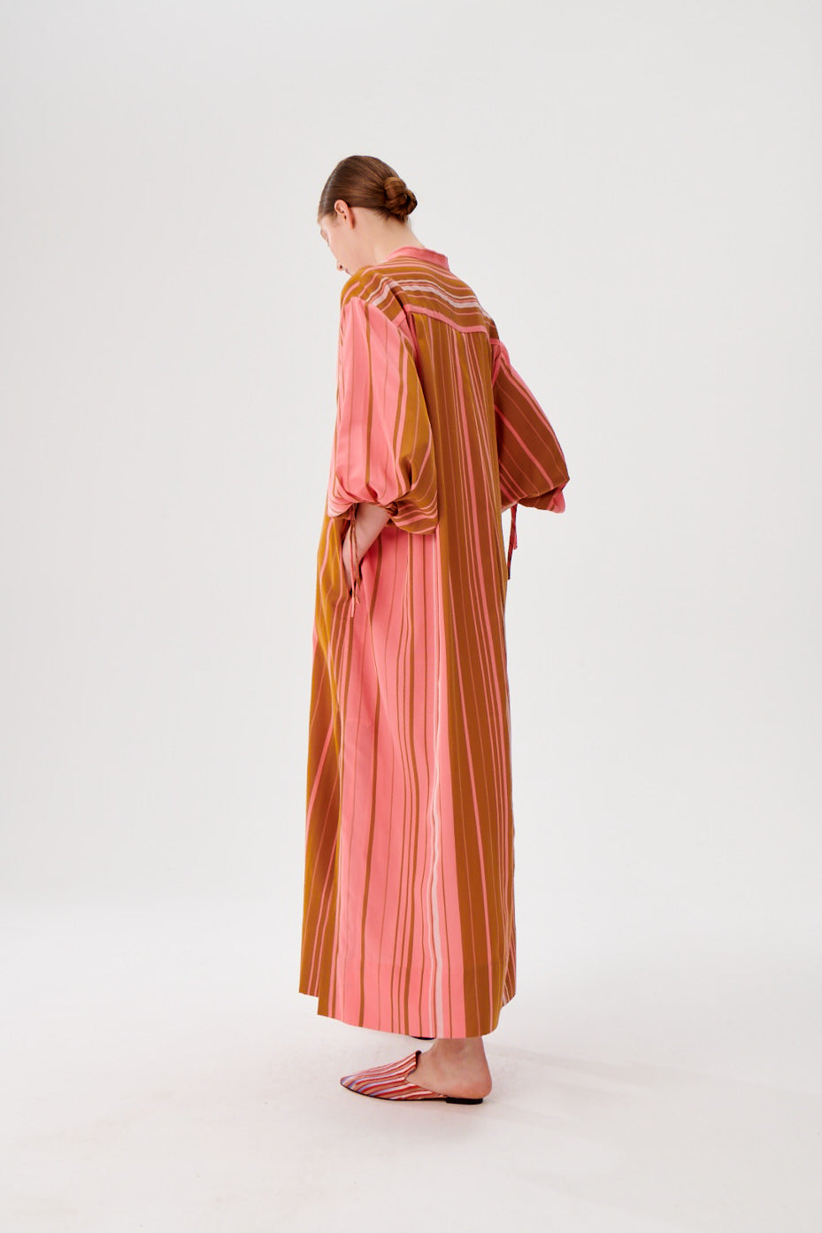Maxi caftan dress back angle, pink and rust striped fabric, split neckline, loose maxi silhouette.