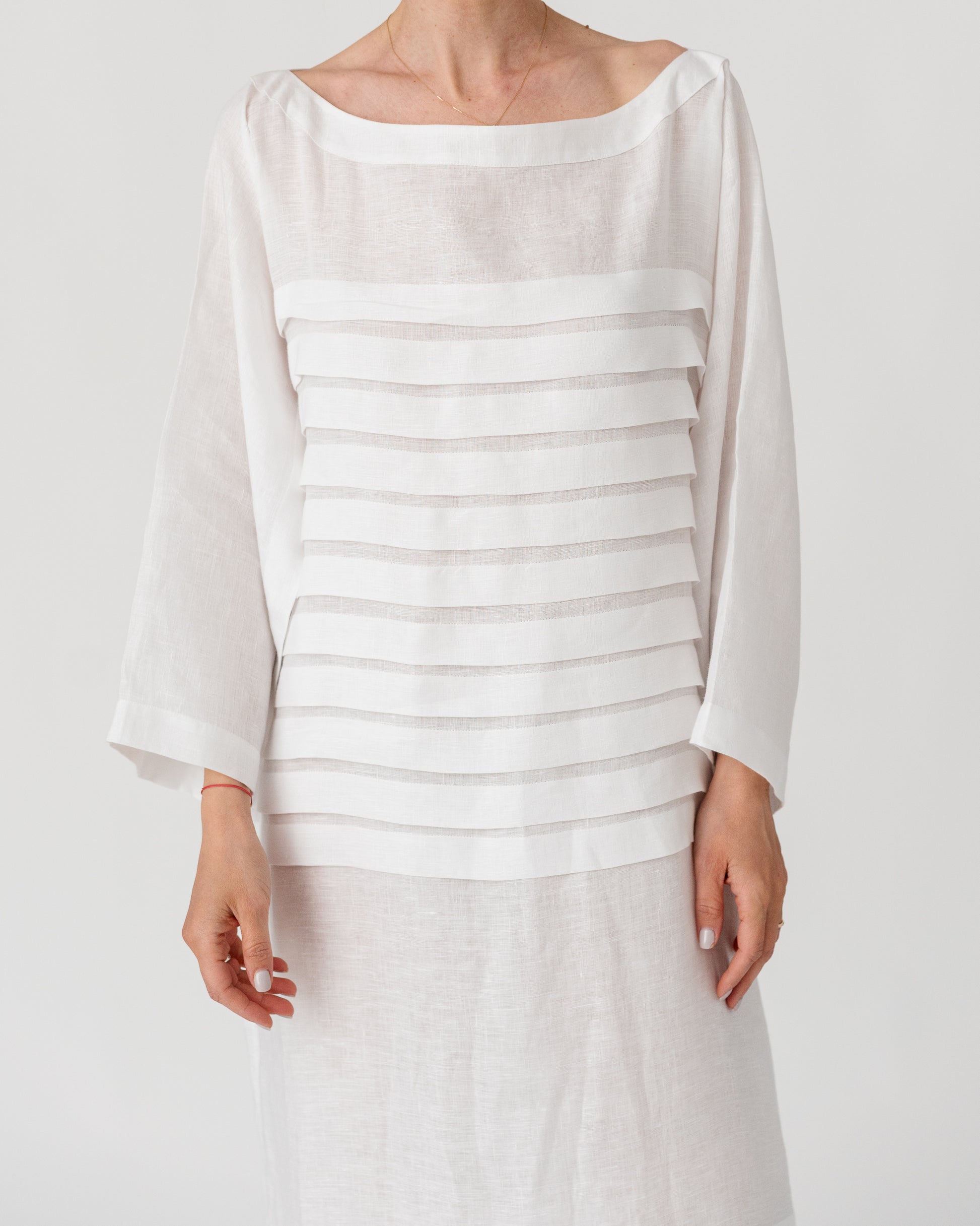Light white maxi dress with wide round neckline and horizontal stripe bands