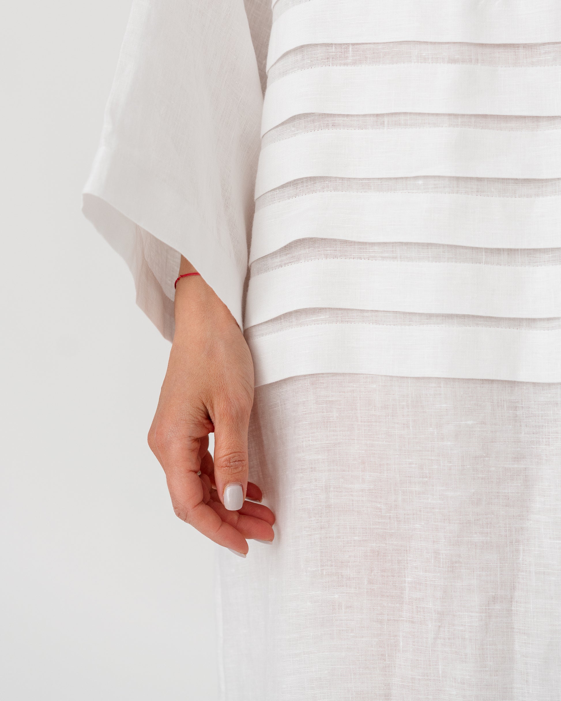 Light white dress fabric close-up with horizontal stripe bands