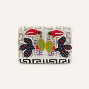 Cream fabric clutch with colorful elephant embroidery and Greek key border